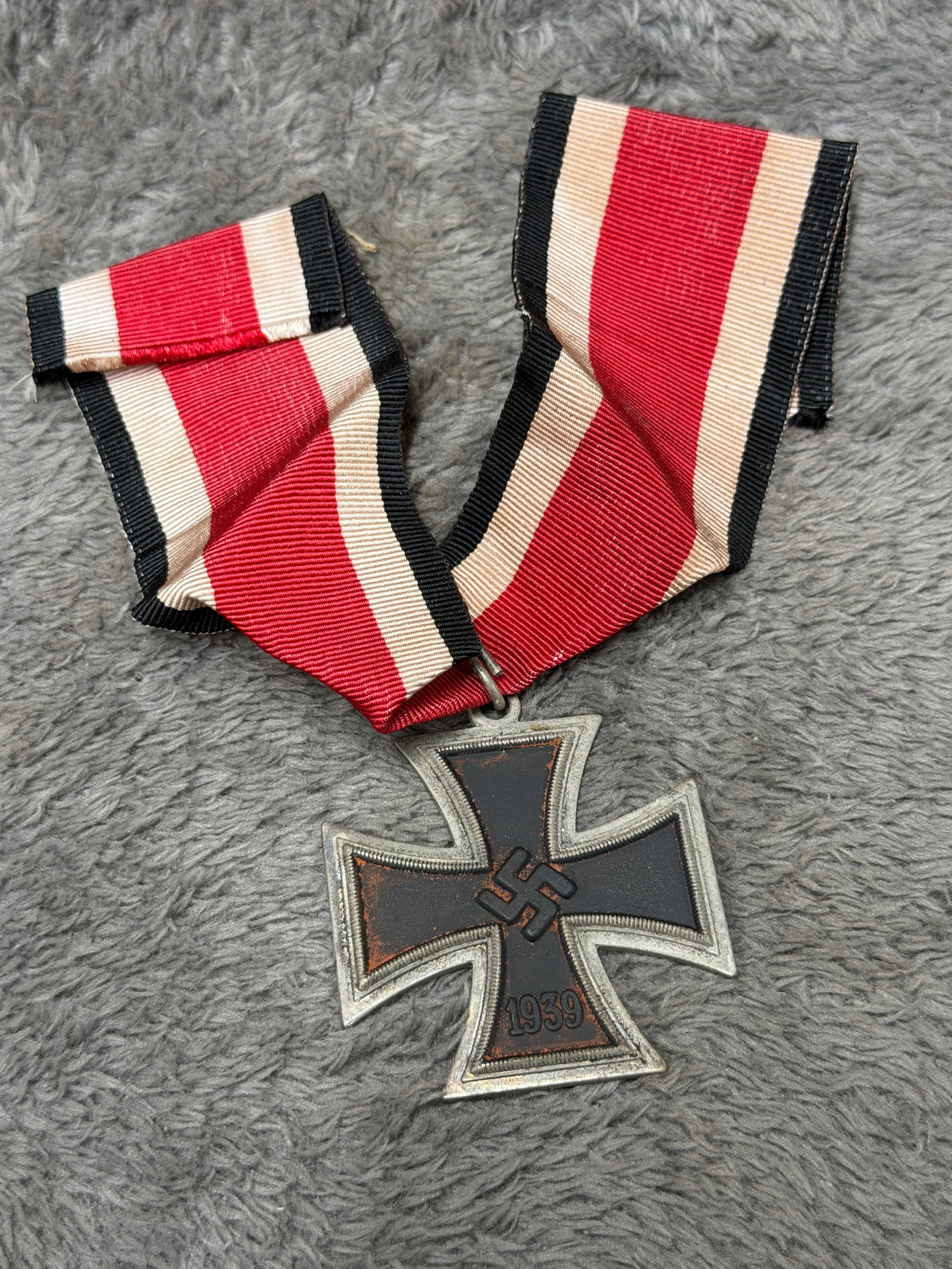 WWII German 1939 Iron Cross 2nd Class Medal with Full Ribbon: A striking WWII German Iron Cross 2nd Class featuring the traditional cross pattée form with a blackened central field surrounded by a contrasting silver-colored beaded inner border and outer frame. 