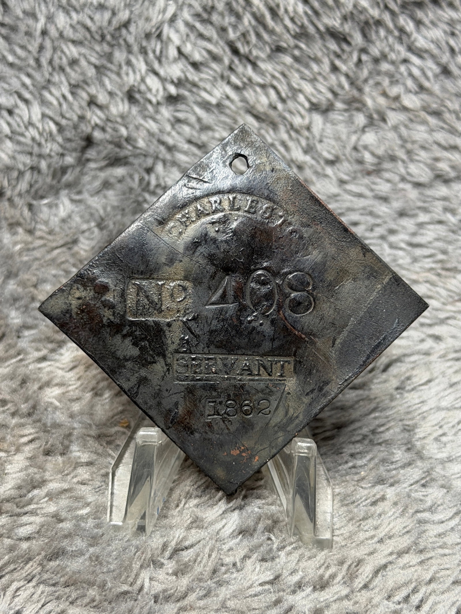 1862 Charleston, South Carolina Slave Hire Tag – Servant No. 408: Civil War-era Charleston, South Carolina slave hire tag bearing the occupational designation “SERVANT,” identification number 408, and the date 1862. The diamond-shaped metal tag is pierced at