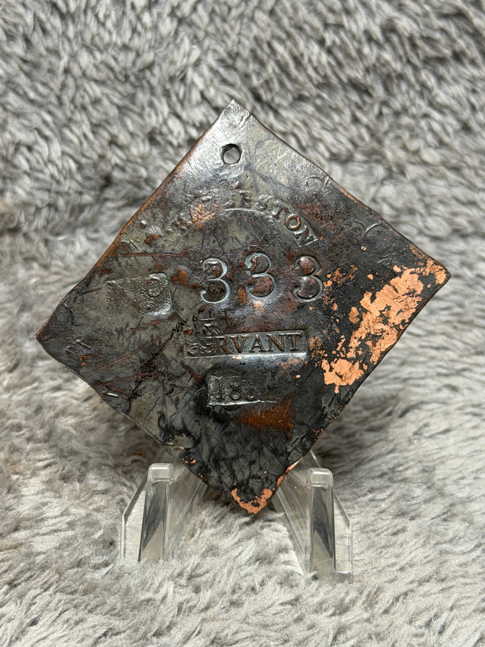 1860 Charleston, South Carolina Slave Hire Tag – Servant No. 333: Charleston, South Carolina slave hire tag bearing the occupational designation “SERVANT,” identification number 333, and what appears to be the date 1860. The diamond-shaped metal tag features