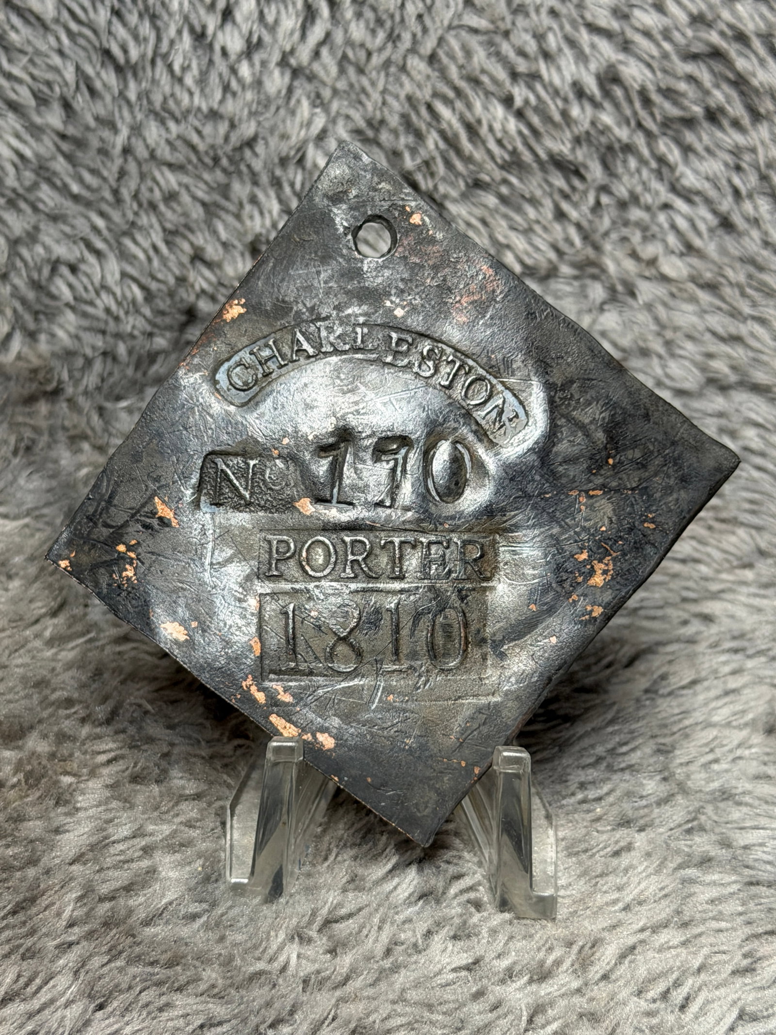 1810 Charleston, South Carolina Slave Hire Tag – Porter No. 170: Charleston, South Carolina slave hire tag bearing the occupational designation “PORTER,” identification number 170, and the date 1810. The diamond-shaped copper-alloy tag features a pierced su
