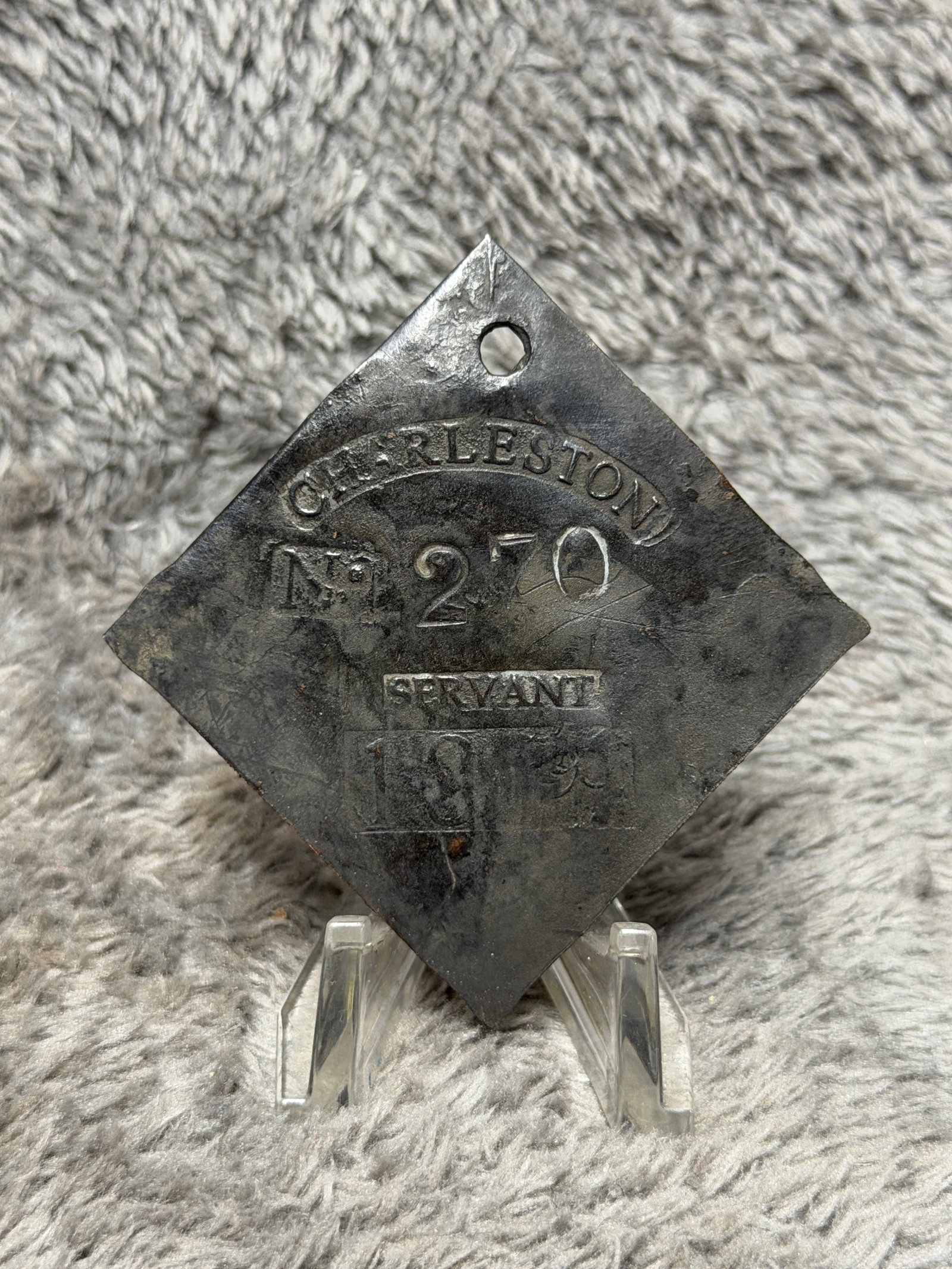 1819 Charleston, South Carolina Slave Hire Tag – Servant No. 270: Charleston, South Carolina slave hire tag bearing the occupational designation “SERVANT,” identification number 270, and the date 1819. The substantial diamond-shaped copper-alloy tag is pierc