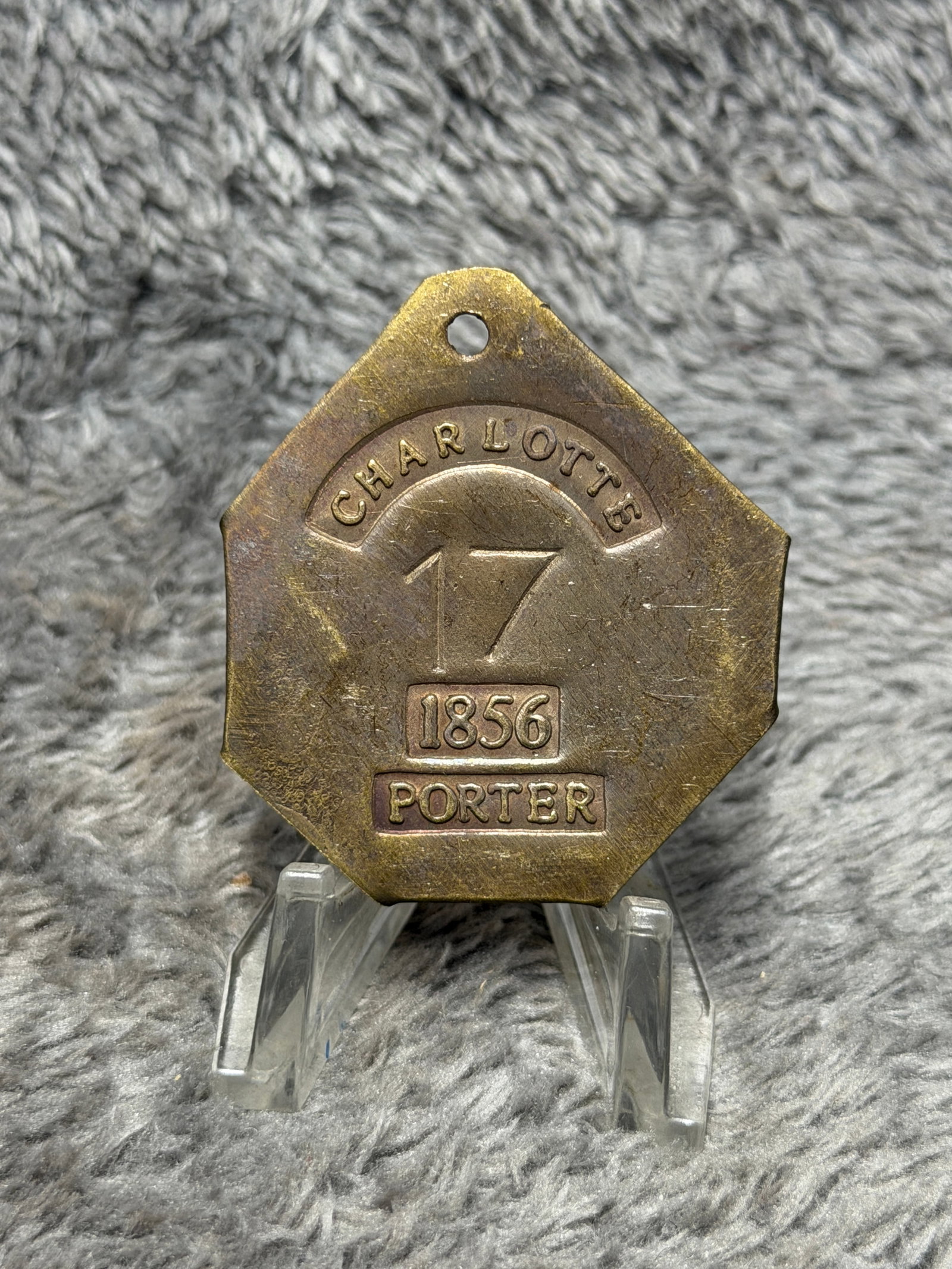 1856 Charleston, South Carolina Slave Hire Tag – Porter No. 17: Charleston, South Carolina slave hire tag dated 1856 and designated for the occupation of “PORTER,” bearing the prominently struck identification number 17. The substantial multi-sided brass o