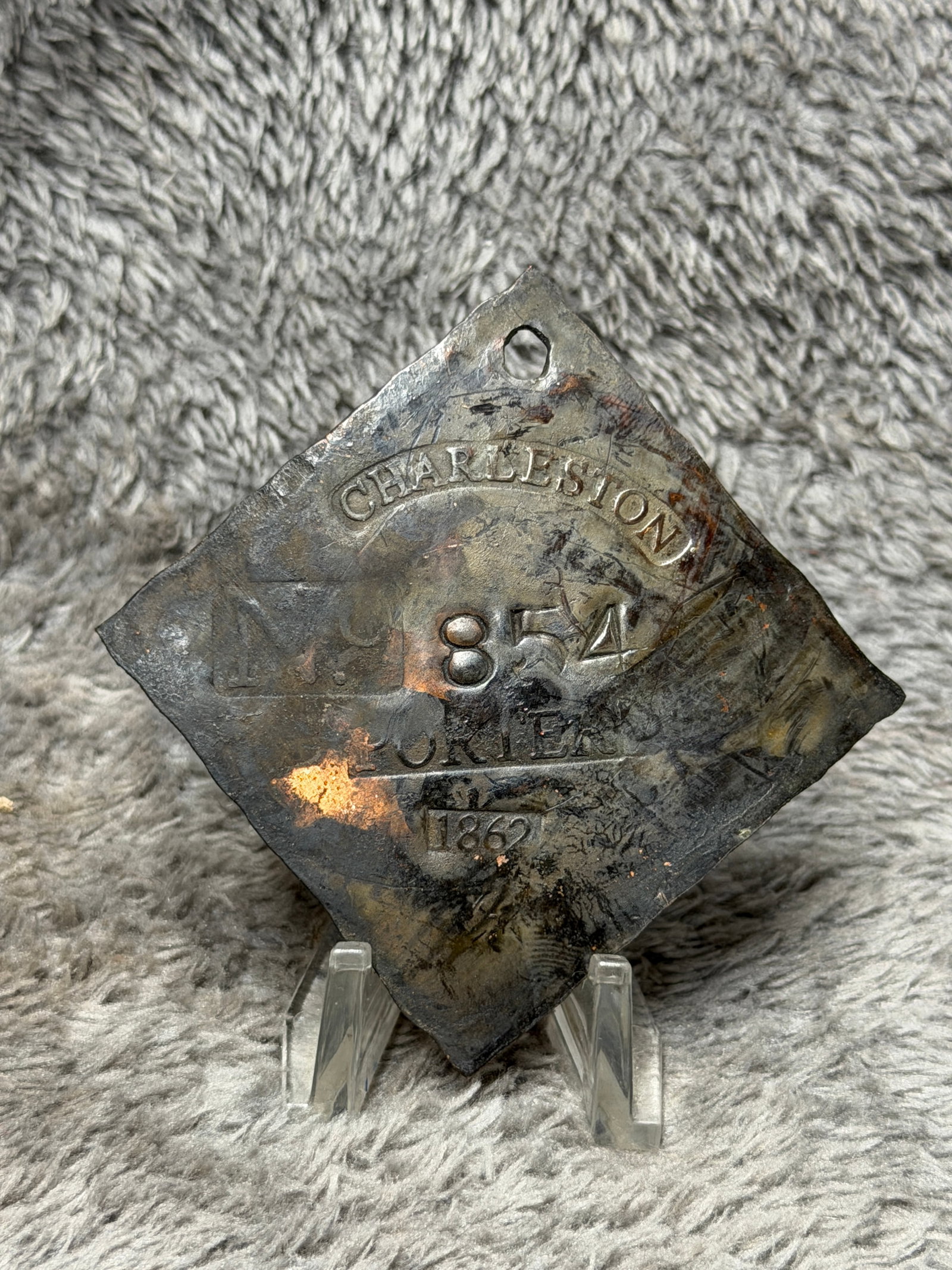 1862 Charleston, South Carolina Slave Hire Tag – Porter No. 854: Charleston, South Carolina slave hire tag dated 1862 and designated “PORTER,” bearing the identification number 854. This substantial diamond-shaped copper-alloy tag features a pierced suspens