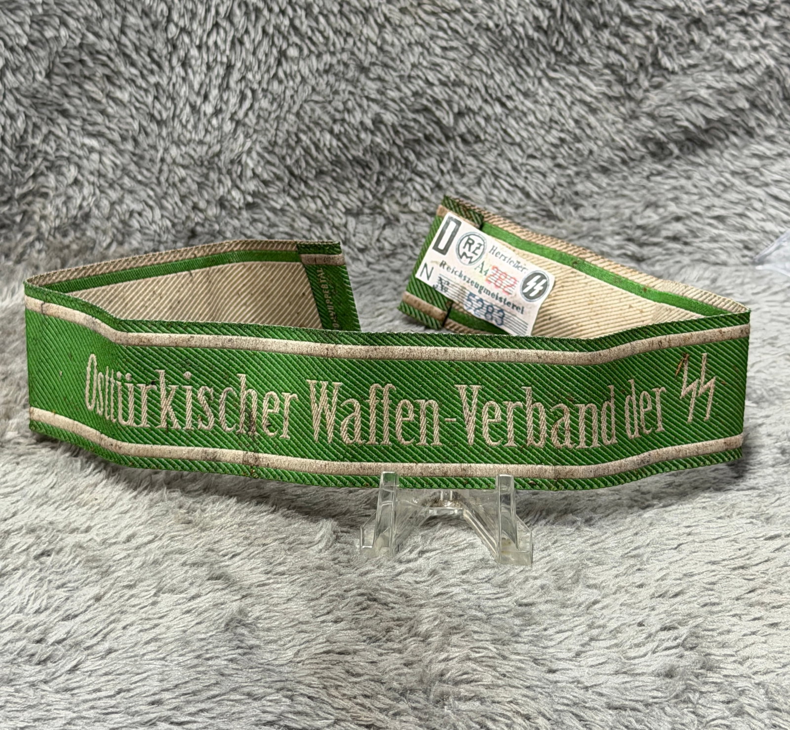WWII German SS Osttürkischer Waffen-Verband Officer’s Cuff Title – RZM Tagged: Distinctive WWII German SS cuff title associated with the Osttürkischer Waffen-Verband der SS, displaying the formation name embroidered across a rich green ribbed field in light-colored Gothic lette