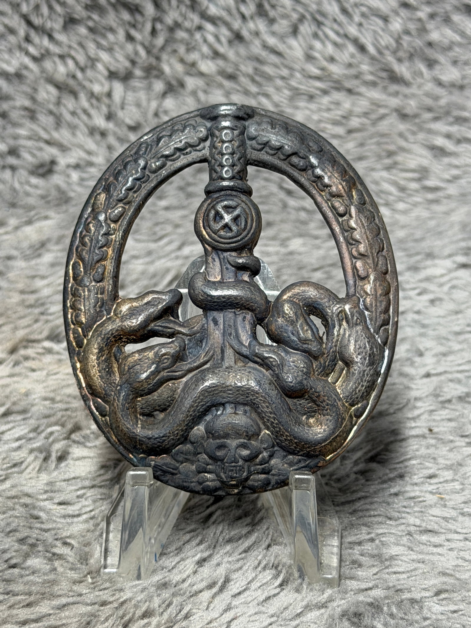 WWII German Anti-Partisan Warfare Badge – Snake, Sword & Skull Design: WWII German Anti-Partisan Warfare Badge featuring the distinctive oval openwork design associated with the Bandenkampfabzeichen, an award instituted during the Second World War for personnel engaged i