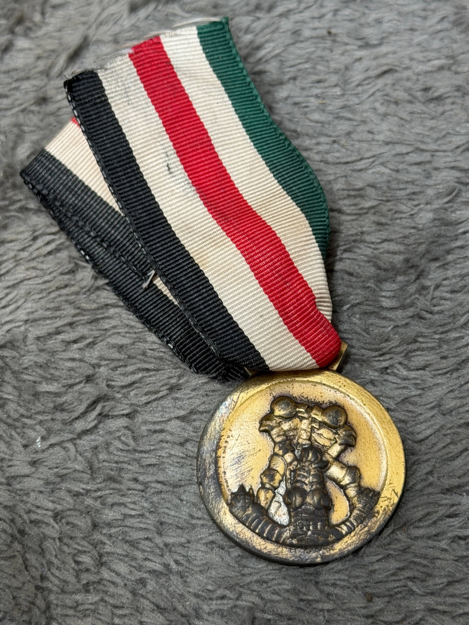 WWII German-Italian Campaign Medal – Italo-German Africa Campaign Award: WWII German-Italian campaign medal commemorating the joint Axis military operations in North Africa, suspended from its distinctive striped ribbon incorporating the national colors associated with Ger
