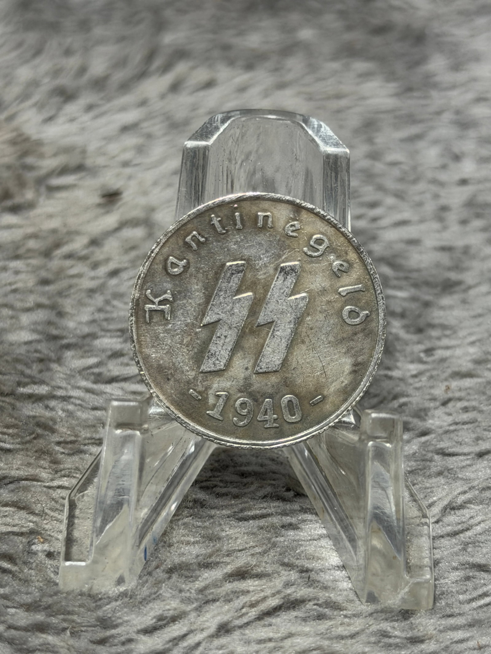 WWII German Waffen-SS Kantinegeld 50 Reichspfennig Canteen Token – 1940: Striking WWII German Waffen-SS canteen or mess token bearing the raised SS runes at center with the inscription “Kantinegeld” above and the date “1940” below. The reverse is prominentl