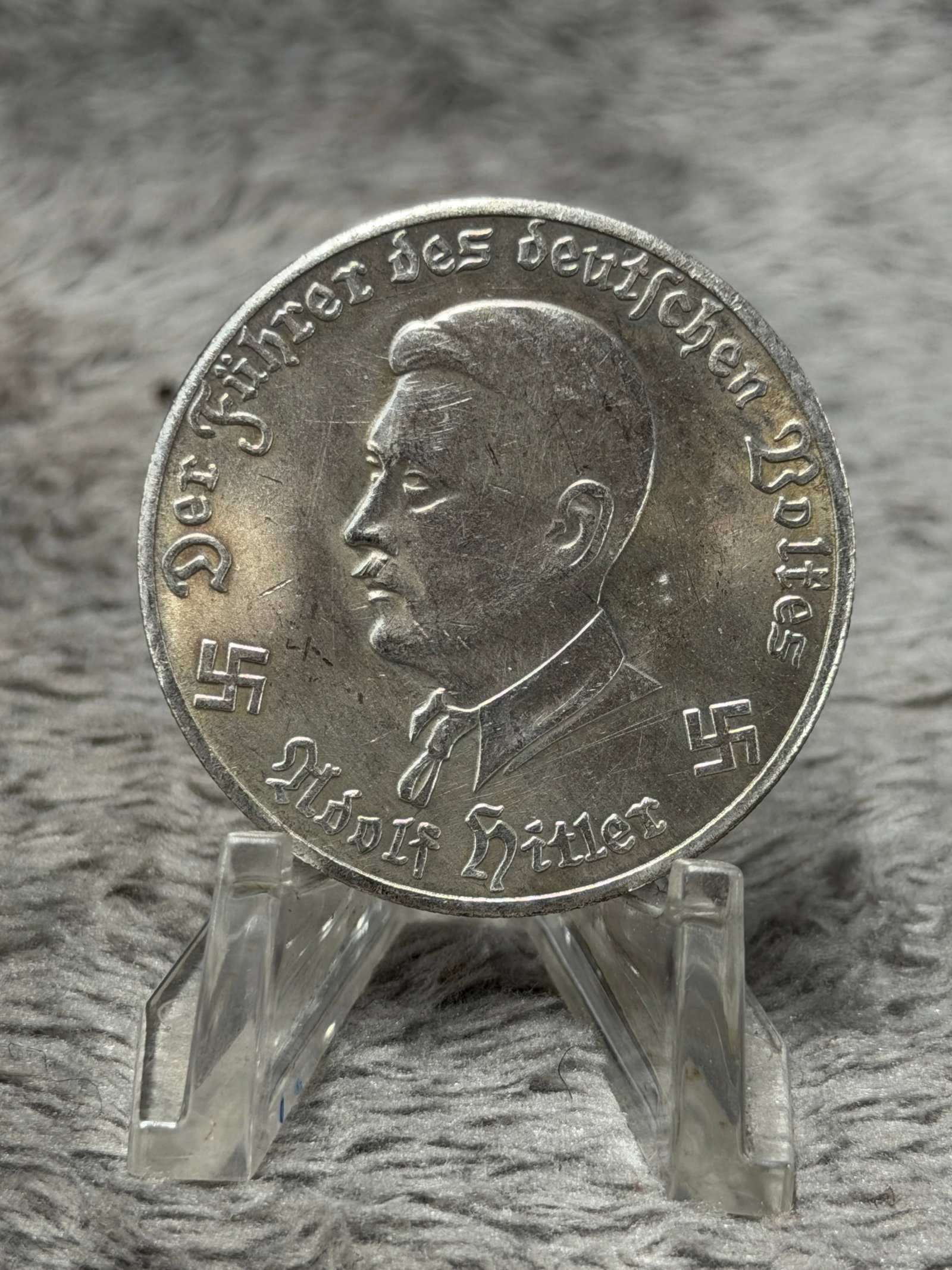 WWII German Adolf Hitler 1942 Deutsches Reich 10 Mark Aircraft Commemorative Coin: Striking WWII German commemorative coin or medallion dated 1942, featuring a left-facing portrait of Adolf Hitler surrounded by the German inscription “Der Führer des deutschen Volkes,” with 