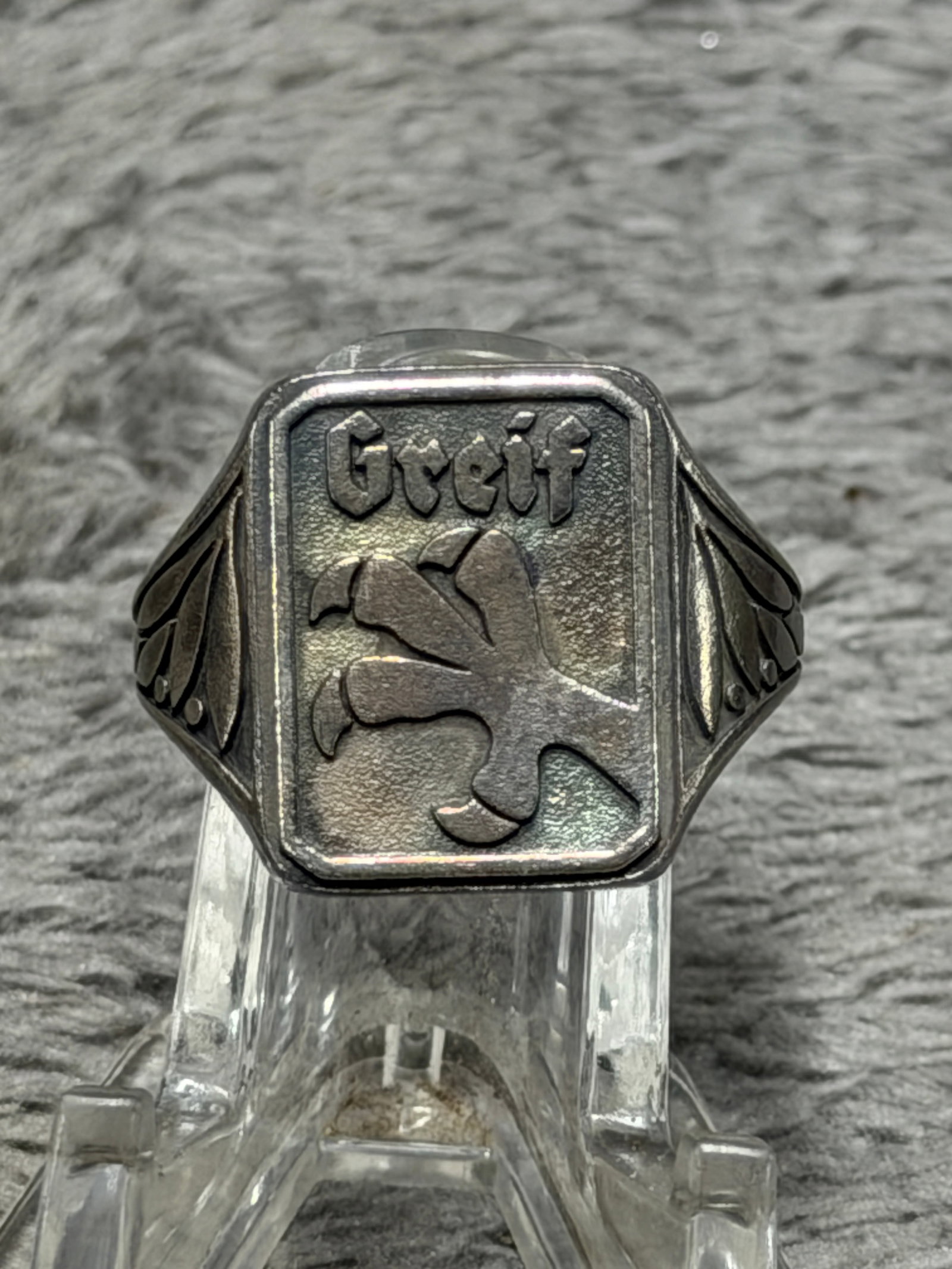 WWII German “Greif?? 1944 800 Silver Military Signet Ring – Regiment 411: Striking WWII German military commemorative signet ring featuring a large rectangular face with the raised Gothic inscription “Greif” above a prominent heraldic griffin device. The shoulders a