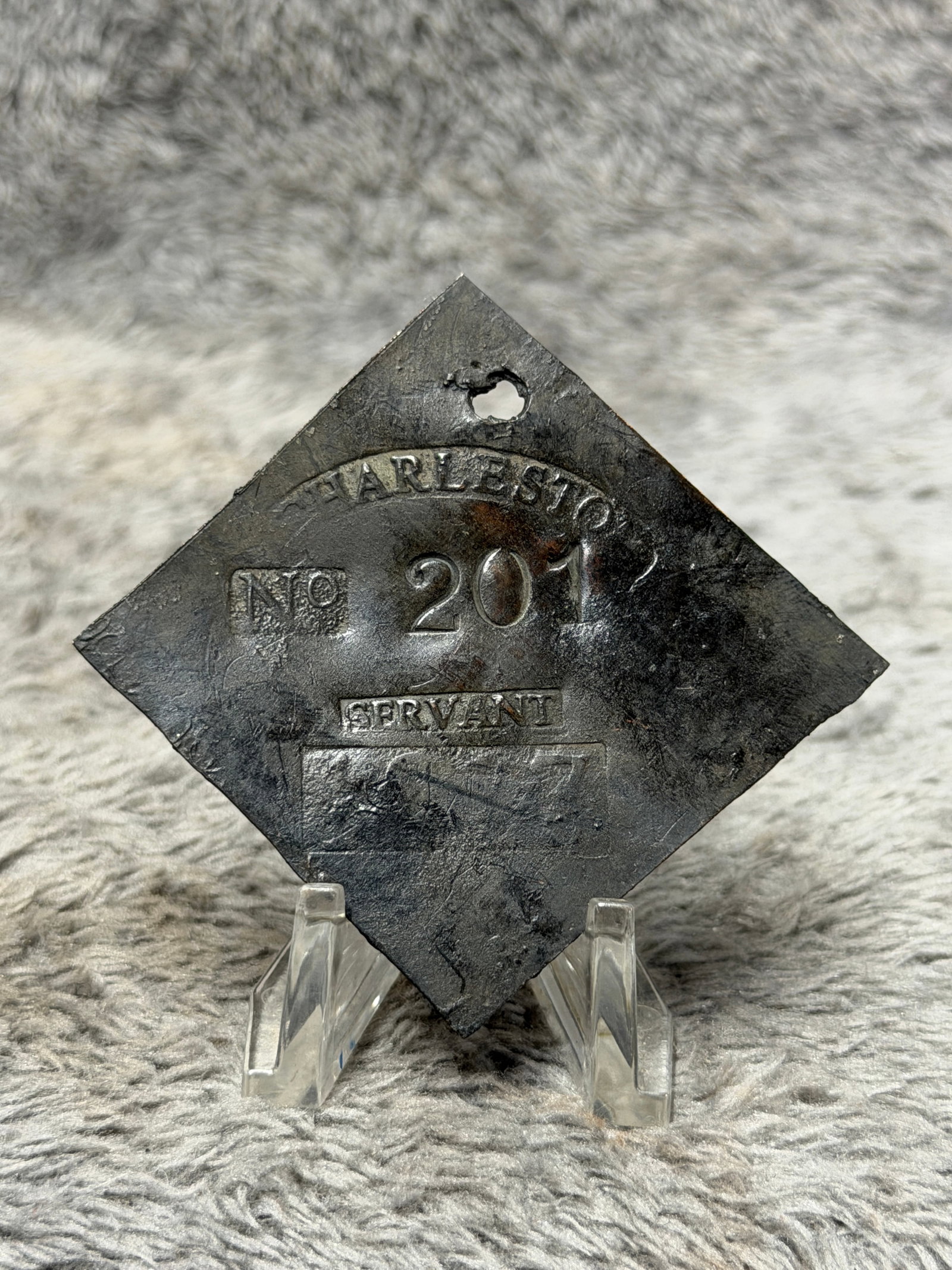 1817 Charleston South Carolina No. 201 Servant Slave Hire Identification Tag: Historically significant 1817 Charleston, South Carolina slave hire identification tag, fashioned in a distinctive diamond-shaped metal form with a pierced suspension hole near the upper point. The fa