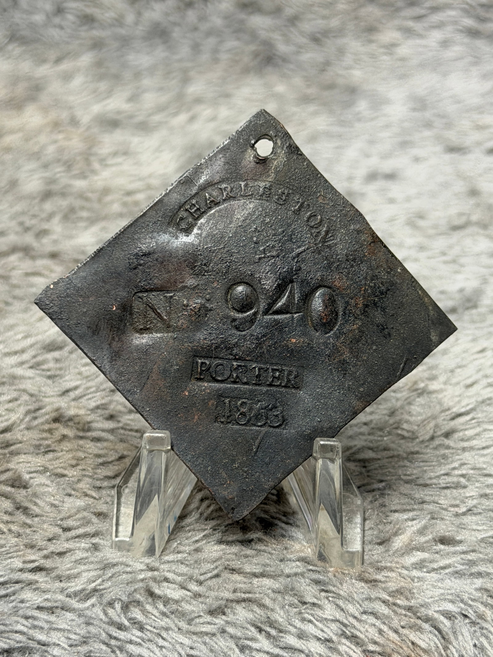 1833 Charleston South Carolina No. 940 Porter Slave Hire Identification Tag: Historically significant 1833 Charleston, South Carolina slave hire identification tag, formed in the distinctive diamond-shaped configuration with a pierced suspension hole at the upper point. The fa