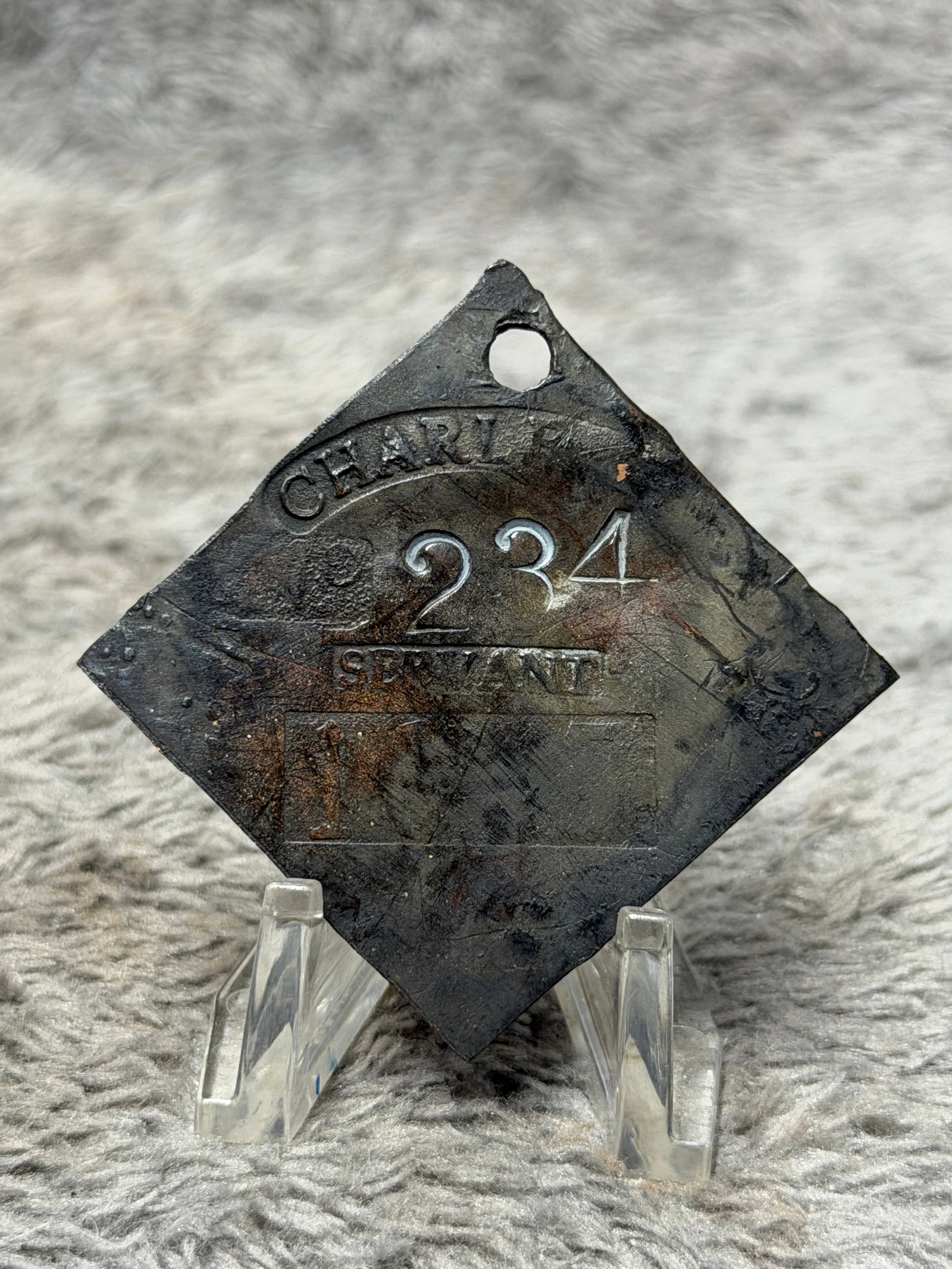 1817 Charleston South Carolina No. 234 Servant Slave Hire Identification Tag: Historically significant 1817 Charleston, South Carolina slave hire identification tag, fashioned in the characteristic diamond-shaped form with a pierced suspension hole at the upper point. The face 