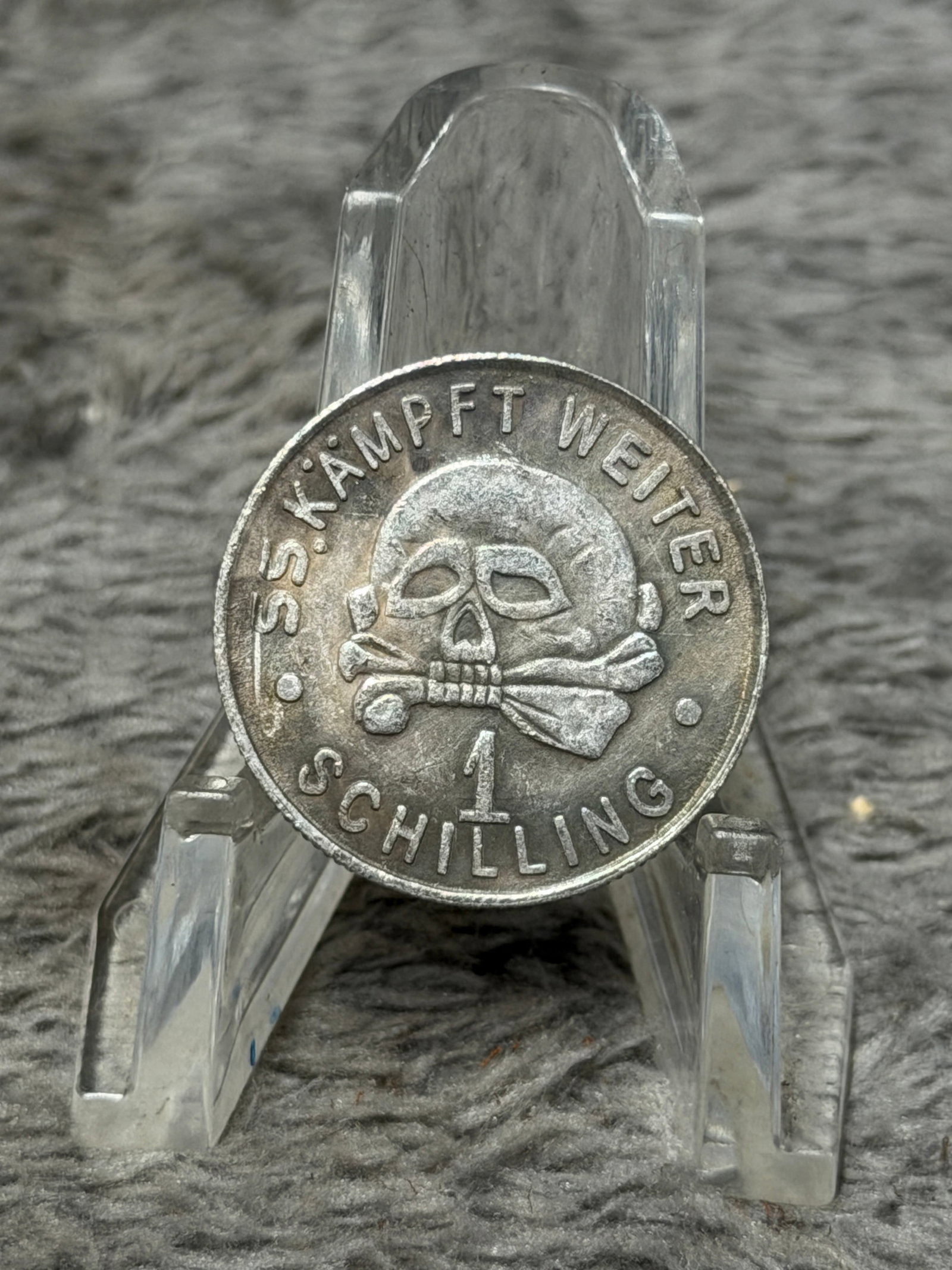 WWII German SS Kampfweiter Schilling 1939 Totenkopf Commemorative Medal: Striking WWII German SS-themed circular medal featuring a prominent raised skull-and-crossbones or Totenkopf motif to the obverse, surrounded by the inscription “SS-KÄMPFT WEITER” with “SCH