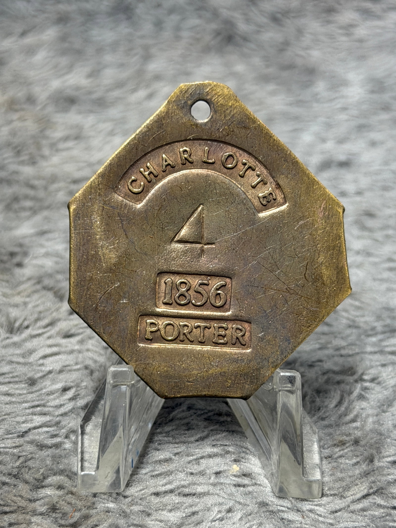 1856 Charleston South Carolina Slave Hire Tag – Porter No. 4: Historically significant 1856 Charleston, South Carolina slave hire tag bearing the occupational designation “PORTER” and the individually assigned number “4.” The heavy brass tag disp