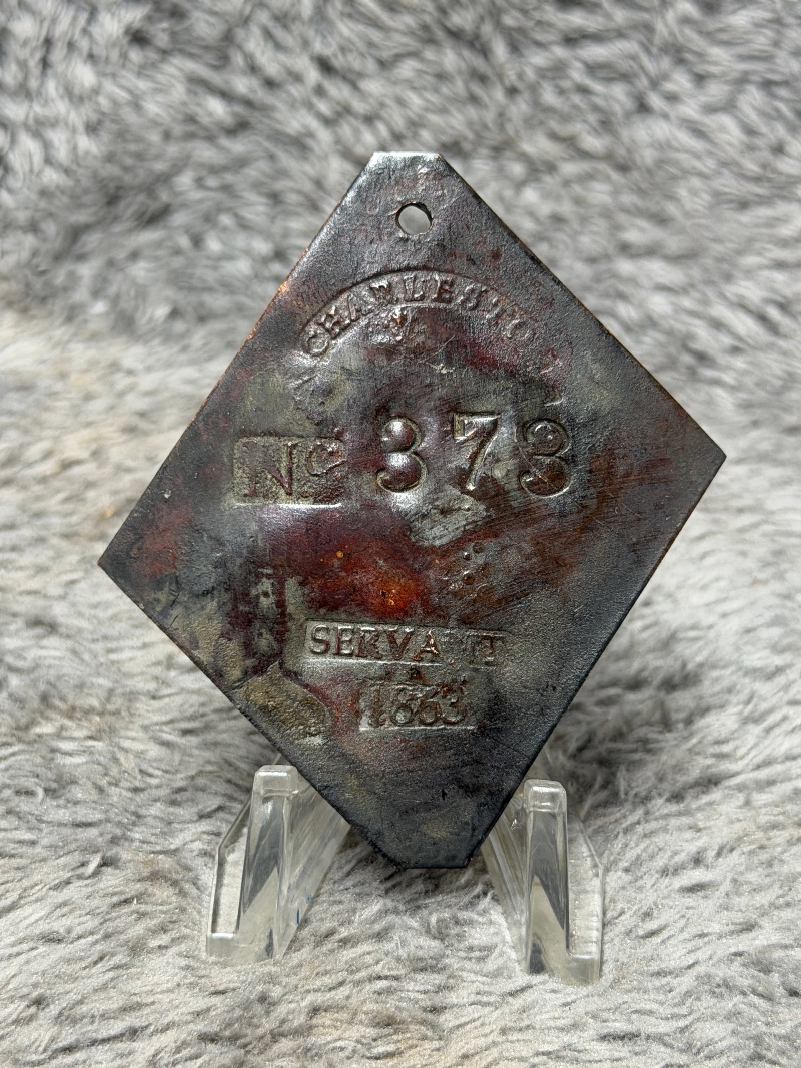 1863 Charleston No. 373 “Servant?? Slave Hire Tag – Civil War Era Identification Badge: Historically significant Civil War-era Charleston slave hire tag dated 1863, fashioned from a thin diamond-shaped metal plate with clipped upper and lower points and a pierced suspension hole near the