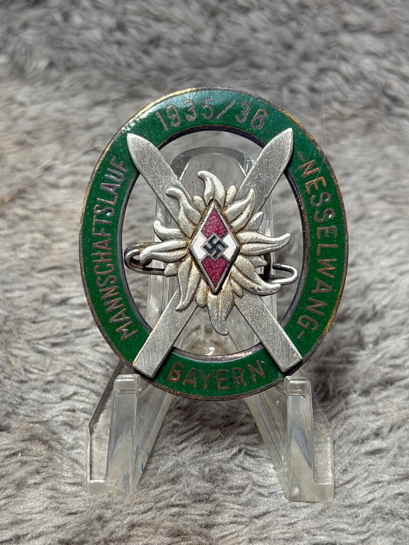 WWII German Hitler Youth 1935/36 Mannschaftslauf Messelwang Bayern Award Badge: Striking WWII German Hitler Youth 1935/36 Mannschaftslauf competition and award badge associated with Messelwang, Bayern (Bavaria). The large oval badge features a green enameled outer border inscribe