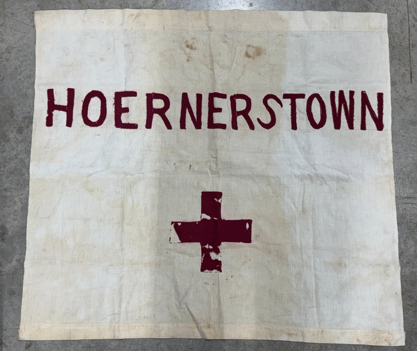 Civil War Hoerners Town Field Hospital Red Cross Medical Flag: Striking Civil War era field hospital or medical station flag prominently displaying the hand-applied inscription “HOERNERSTOWN” across the upper portion with a large dark red cross positioned