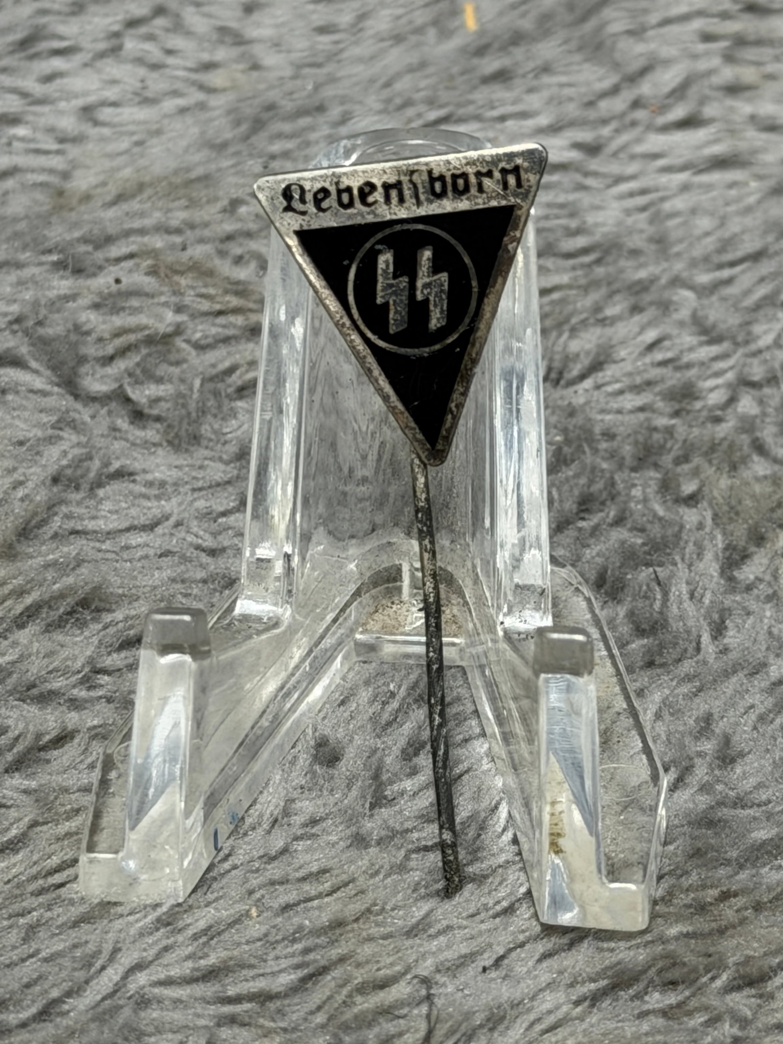 WWII German Waffen-SS “Lebensborn?? Membership Stickpin Badge: WWII German Waffen-SS “Lebensborn” membership stickpin featuring a distinctive inverted triangular form with a black enameled central field, silver-tone border and prominent SS runes enclosed 