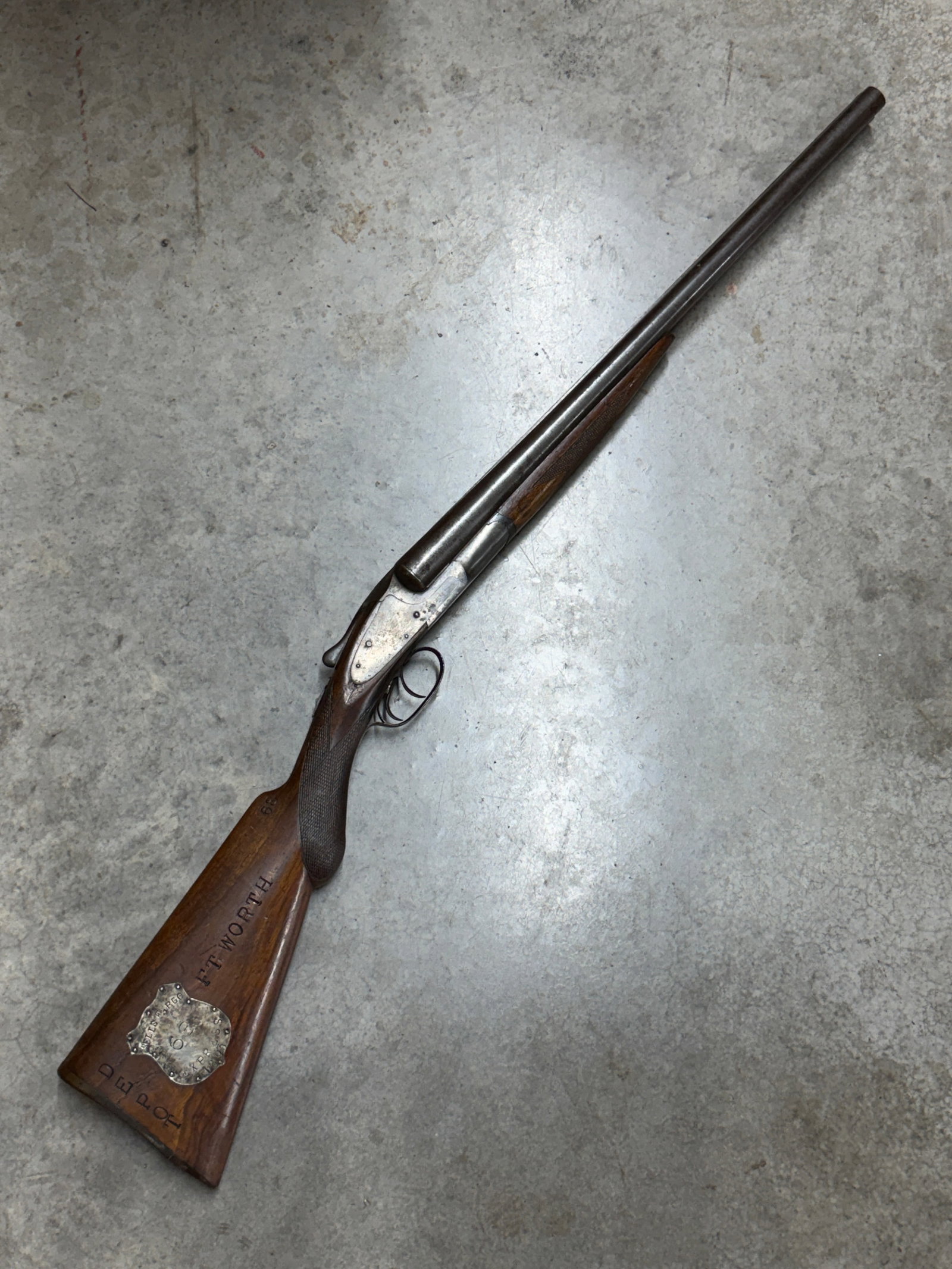 1893 Wells Fargo Express Model 68 Double-Barrel Coach Shotgun – L.C. Smith Marked: Historic double-barrel exposed-hammer shotgun prominently associated through its extensive markings with Wells Fargo Express and marked “L.C. SMITH” on the action. The shotgun features side-by