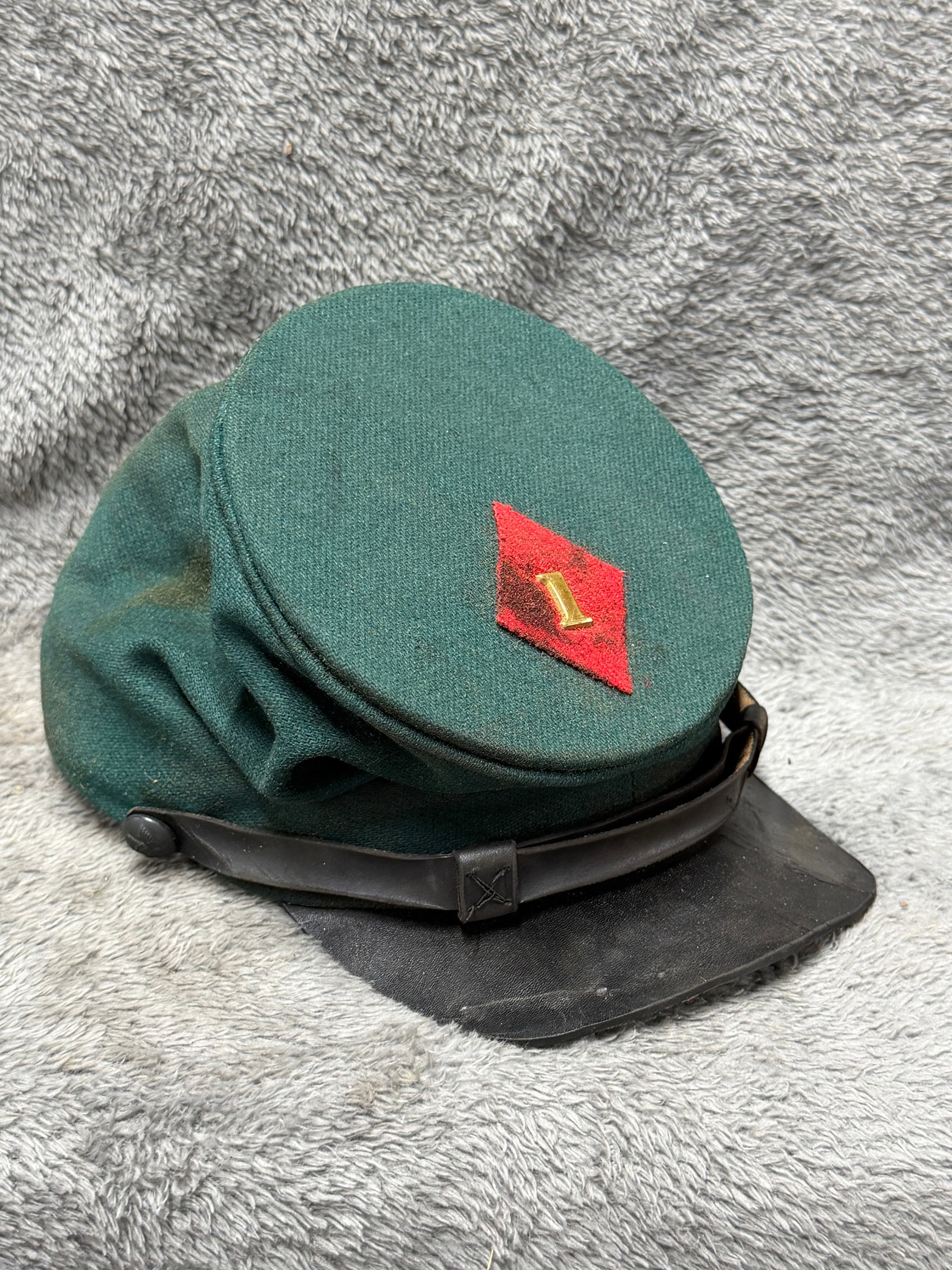Civil War Union Sharpshooter Rifleman Forage Cap Kepi with 1st Regiment Insignia: Civil War period Union sharpshooter rifleman forage cap or kepi constructed with a distinctive dark green wool body, a color closely associated with the specialized riflemen and sharpshooter troops wh