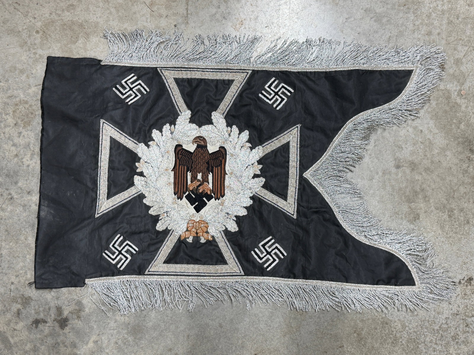 WWII German Third Reich Iron Cross & Eagle Swastika Embroidered Ceremonial Standard Banner: Impressive WWII German Third Reich ceremonial standard or banner constructed on a black textile field with elaborate silver-colored embroidered decoration and heavy fringe. The central composition fea