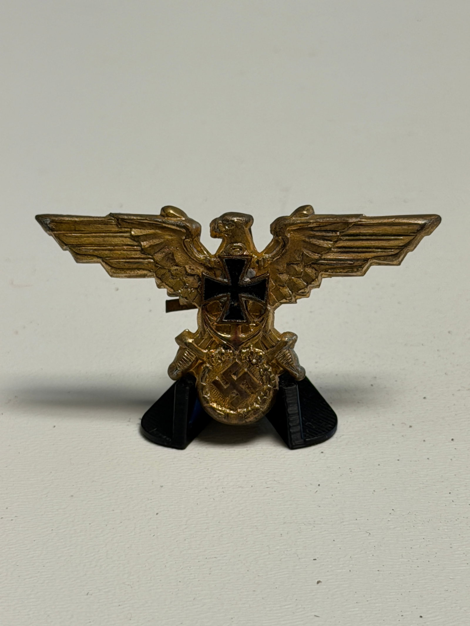 WWII German Third Reich Gilt Eagle & Iron Cross Patriotic Pin with Swastika: WWII German Third Reich gilt-finished metal patriotic pin featuring an elaborate spread-winged eagle composition incorporating several prominent period emblems. The center is dominated by a black enam