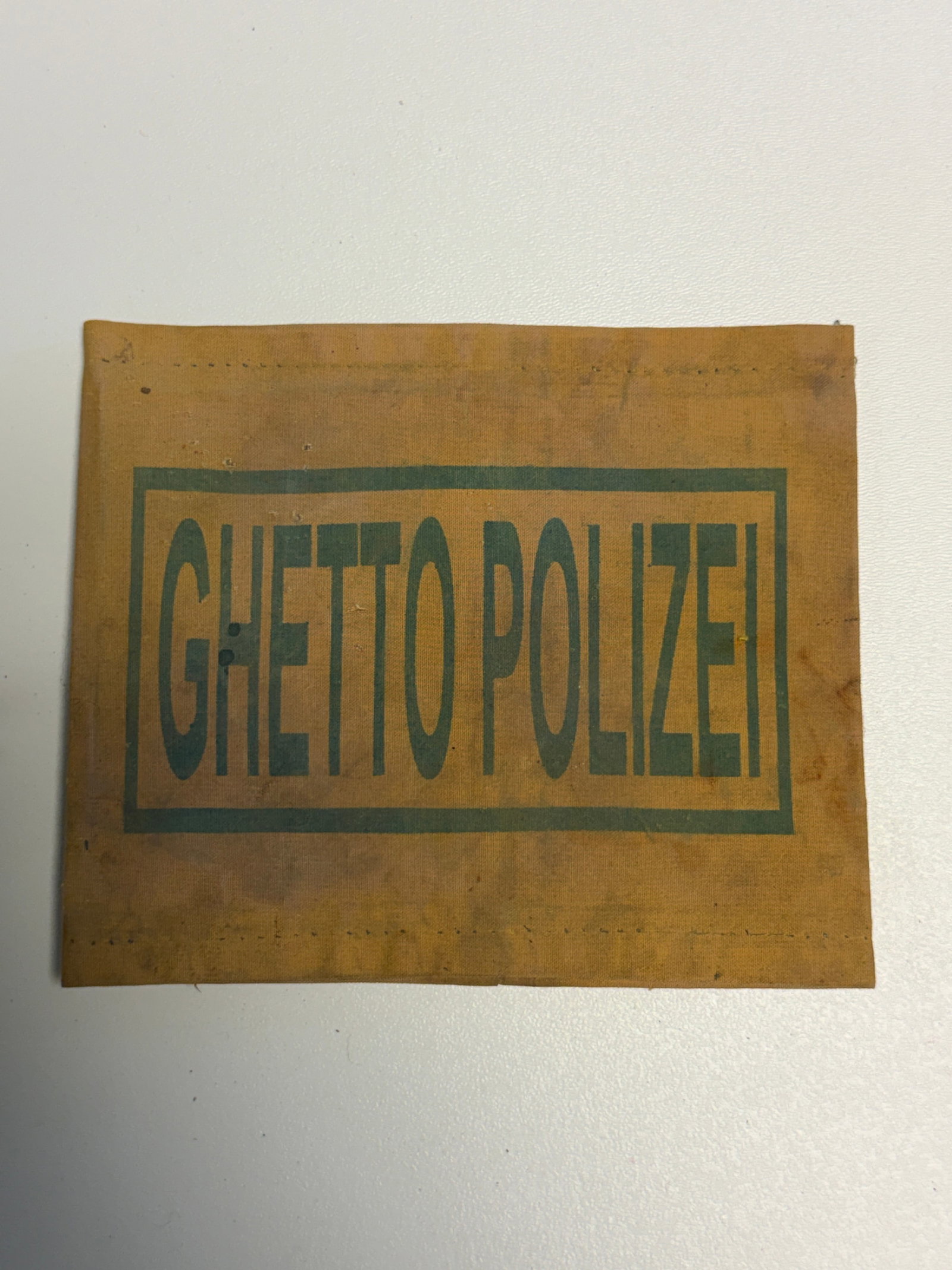 WWII German Ghetto Polizei Jewish Ghetto Police Armband: WWII-era German occupation-period cloth armband bearing the large block inscription “GHETTO POLIZEI” within a rectangular border, identifying it with the Jewish Ghetto Police established withi