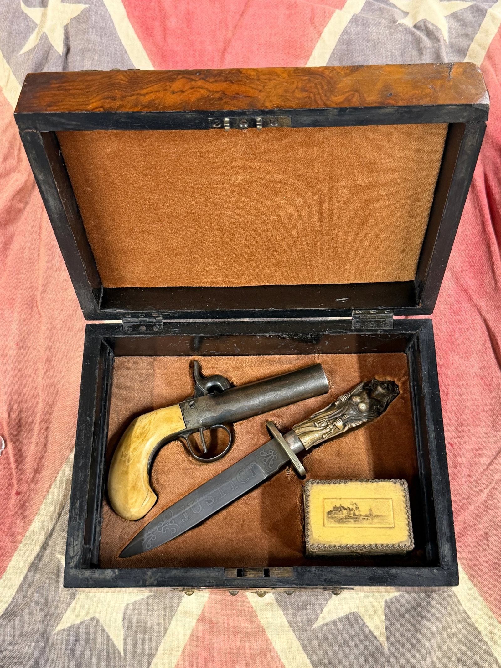 Revolutionary War Gentleman’s Cased Boot Pistol & “JUSTICE?? Figural Fighting Knife Set: Striking cased early American weapon set consisting of a compact single-shot percussion boot or pocket pistol, an elaborately decorated fighting knife prominently inscribed “JUSTICE,” and a sm