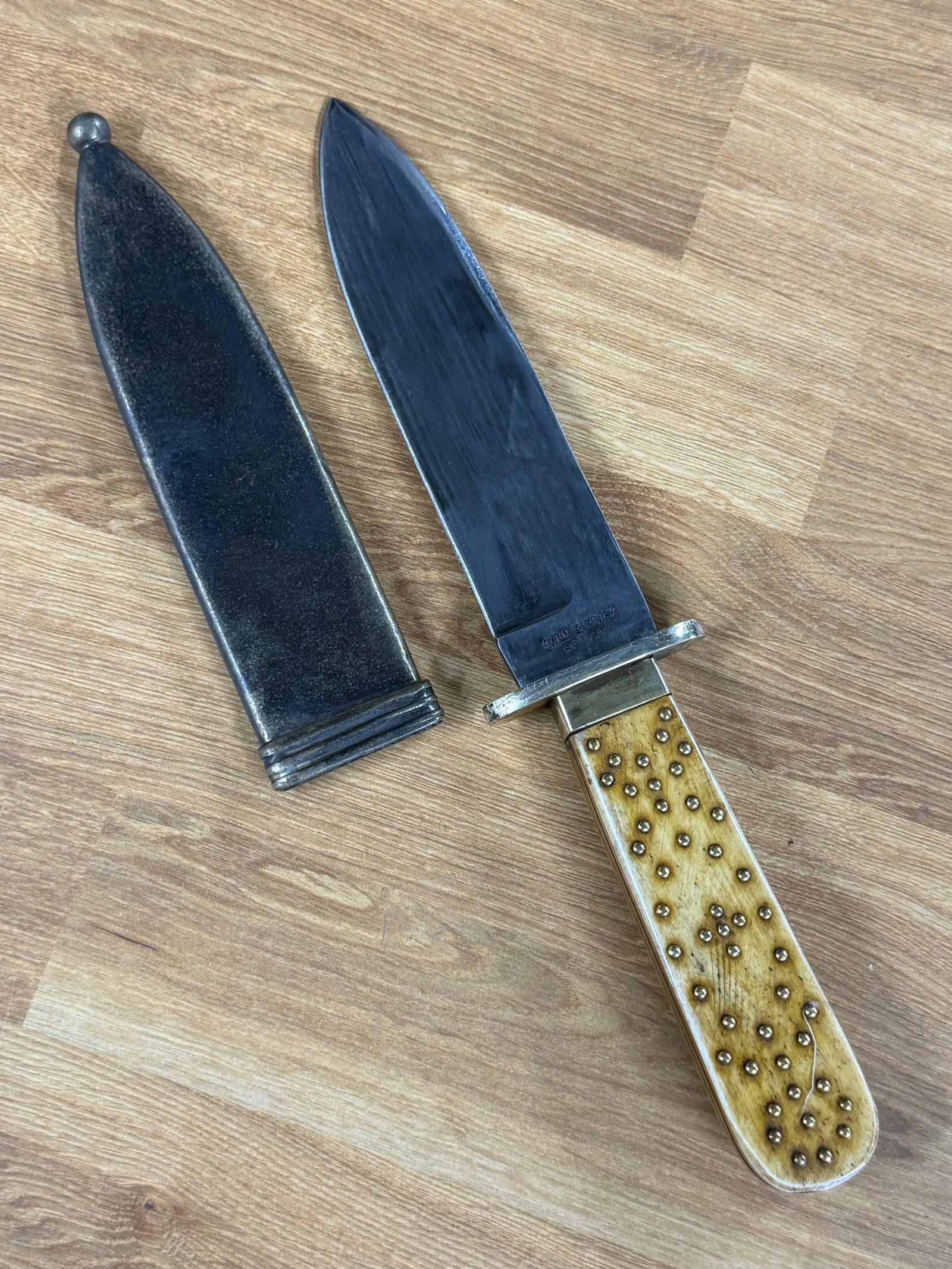 1800s American Frontier Will & Finck San Francisco Bowie Knife with Studded Bone Handle & Metal: An impressive 19th-century American frontier Bowie knife featuring a substantial spear-point steel blade, decorative bone handle and fitted metal sheath. The blade is prominently stamped “WILL & FIN