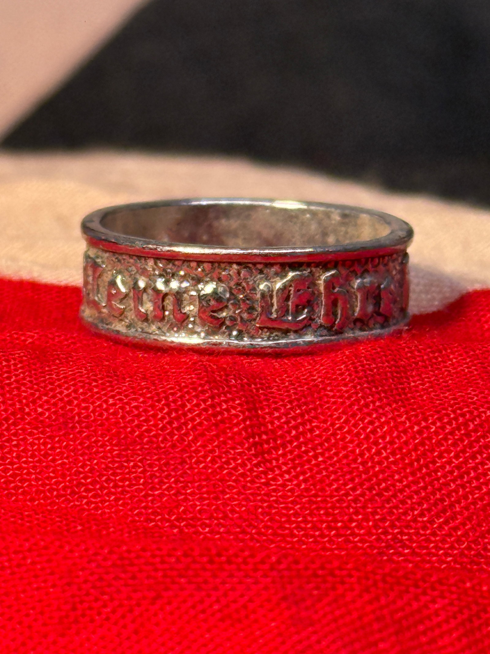 WWII German “Meine Ehre Heißt Treue?? SS Motto Ring – Marked 835: A WWII German SS-associated silver finger ring featuring raised Gothic lettering around the exterior against a textured field. The inscription reads “Meine Ehre heißt Treue,” translating to �