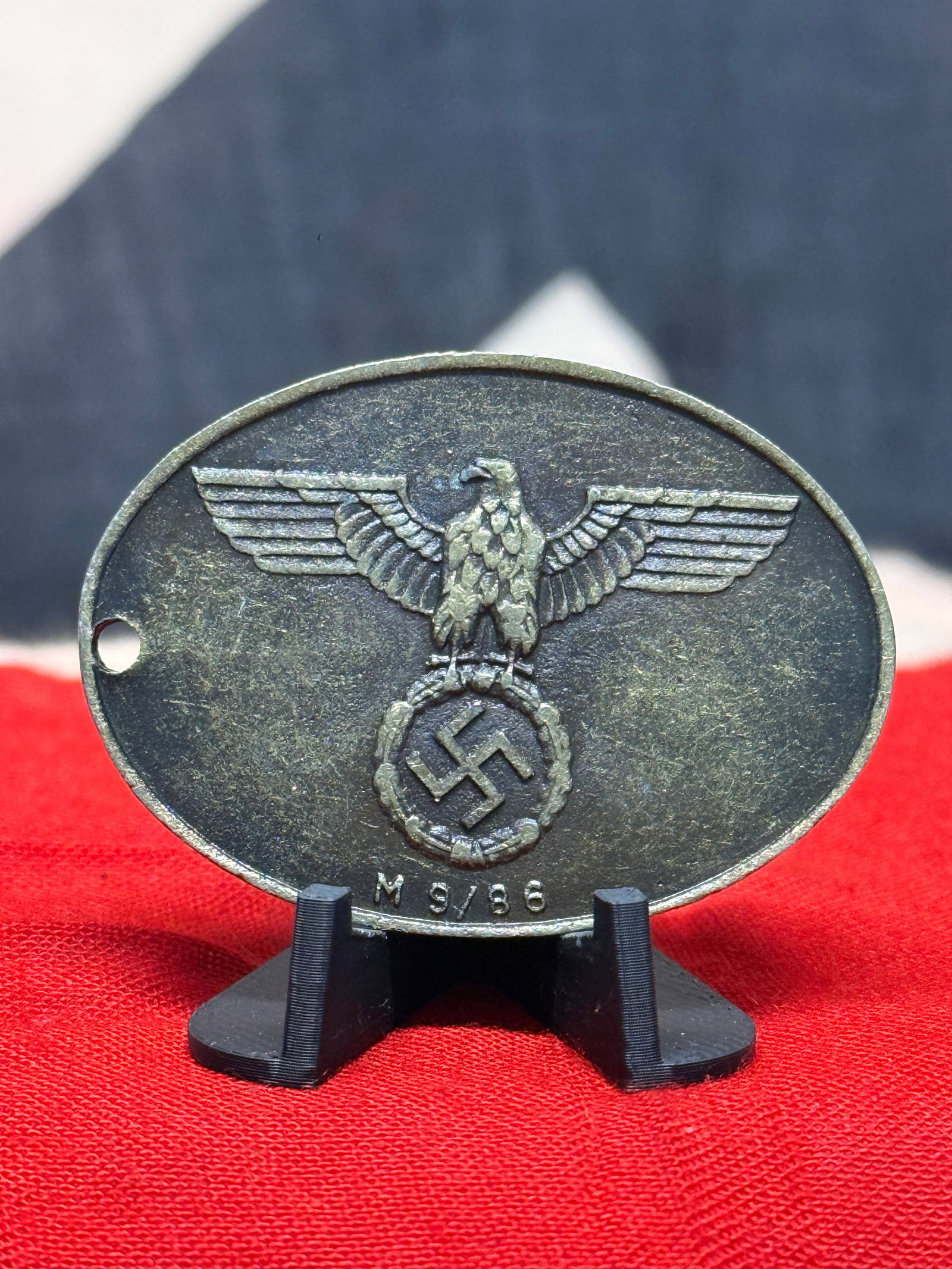 WWII German Geheime Staatspolizei Gestapo Identification Disc No. 8774: An oval German identification disc bearing the raised inscription “GEHEIME STAATSPOLIZEI” on one face together with a separately applied numbered panel reading “8774.” The opposite fac