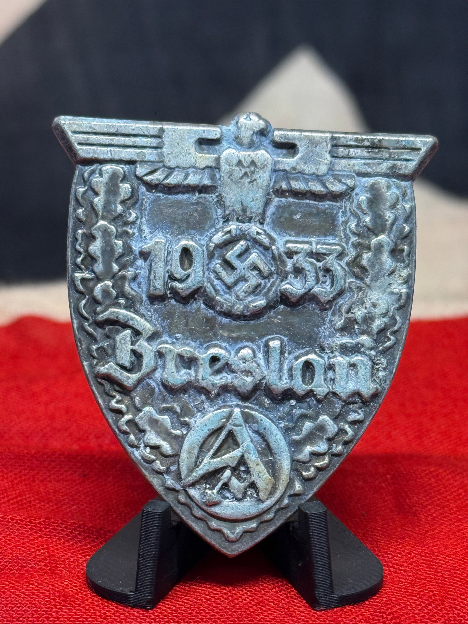 WWII German 1933 Dresden SA Commemorative Rally Badge: A substantial shield-shaped German commemorative badge featuring a spread-winged eagle at the top above the raised date “1933,” with a swastika incorporated prominently between the numerals. A