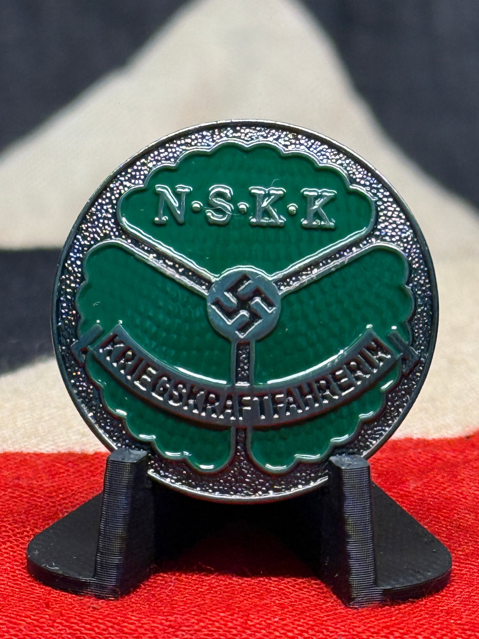 WWII German NSKK Kriegskraftfahrer Green Enamel Motor Transport Badge – Marked M1/35: A striking circular German motor-transport badge associated with the NSKK, or Nationalsozialistisches Kraftfahrkorps, an organization closely connected with motorization, driver training, and transpor