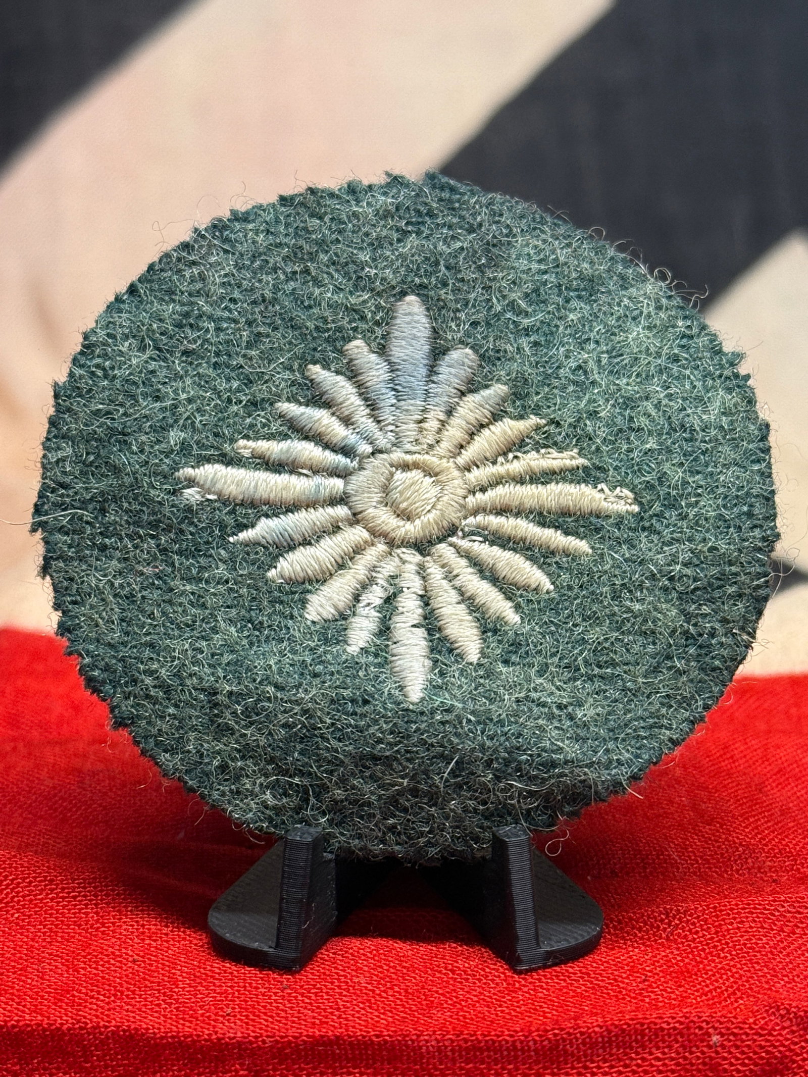 WWII German Army Heer Gebirgsjäger Edelweiss Mountain Troops Sleeve Badge: This WWII German Army cloth insignia features the celebrated Edelweiss emblem associated with the Gebirgsjäger, Germany's specialized mountain troops. The badge is constructed on a circular field-gra