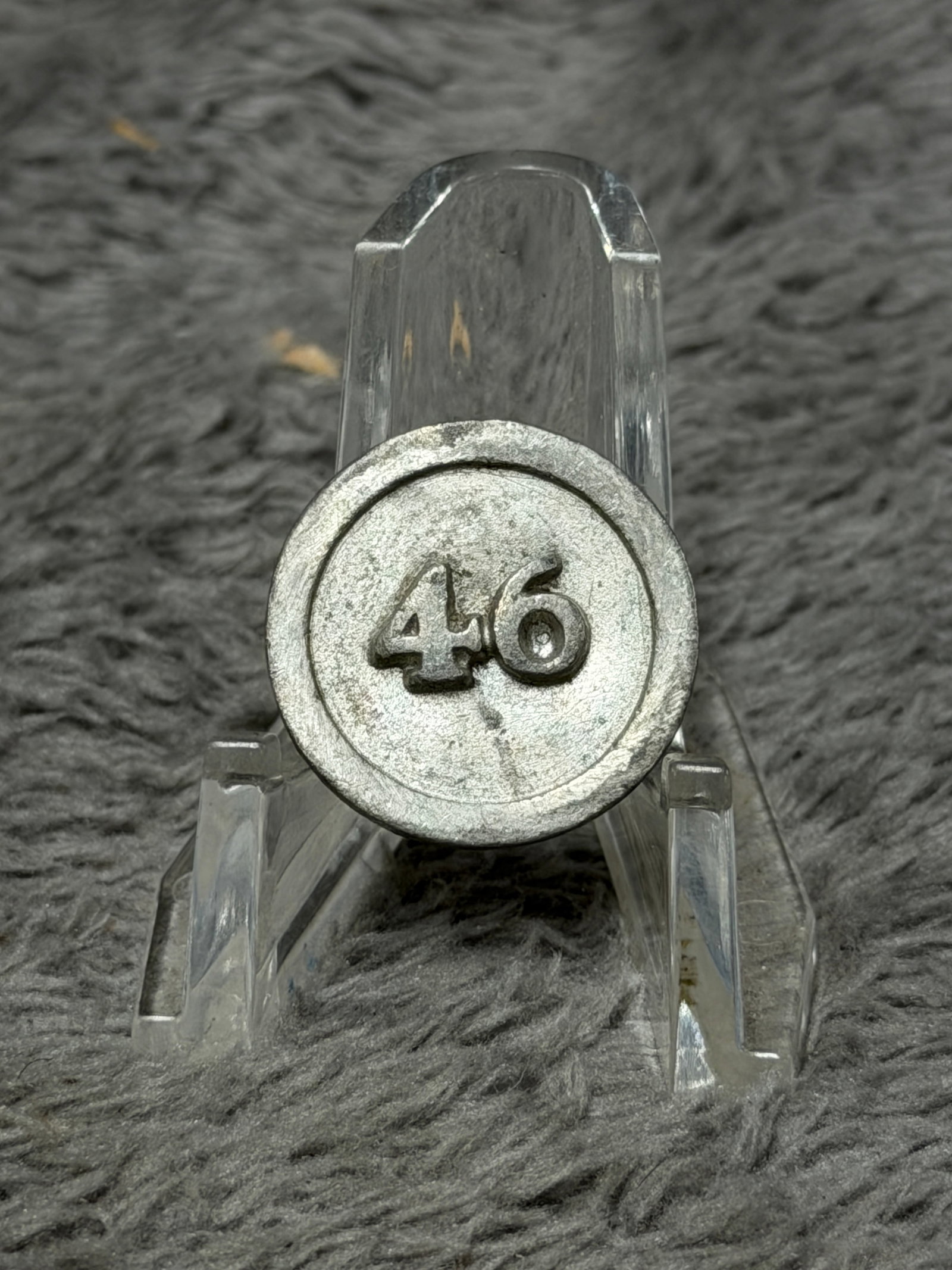 Revolutionary War 46th Regiment Pewter Uniform Button: Revolutionary War period military pewter uniform button attributed to the 46th Regiment, featuring a bold raised “46” centered on the face within a simple circular border. The reverse retains 