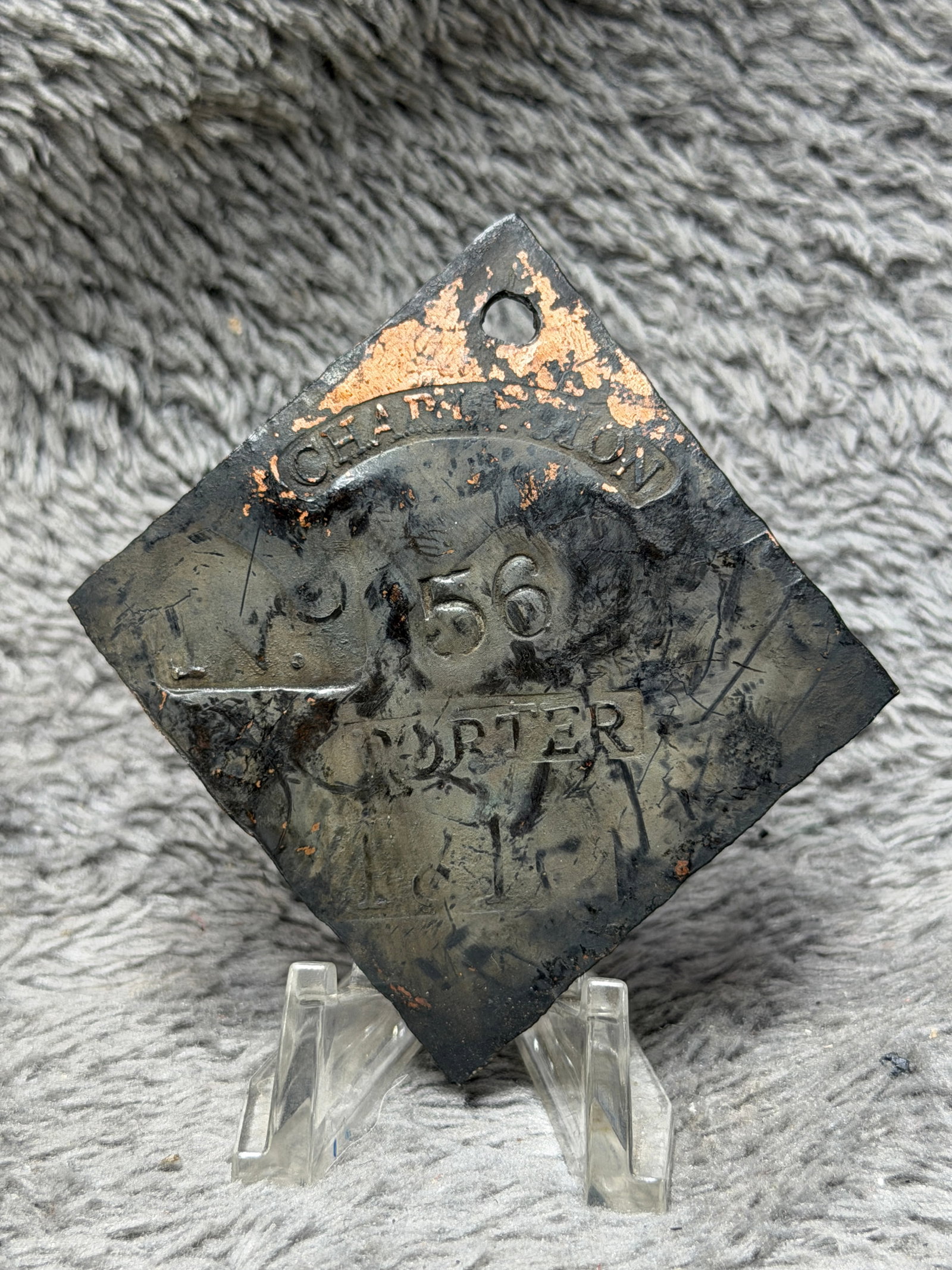 Pre-Civil War Charleston No. 56 Porter Slave Hire Identification Tag: Diamond-shaped Charleston slave hire identification tag bearing the curved “CHARLESTON” marking across the upper portion, the prominently stamped number “56” at center, and the occupat
