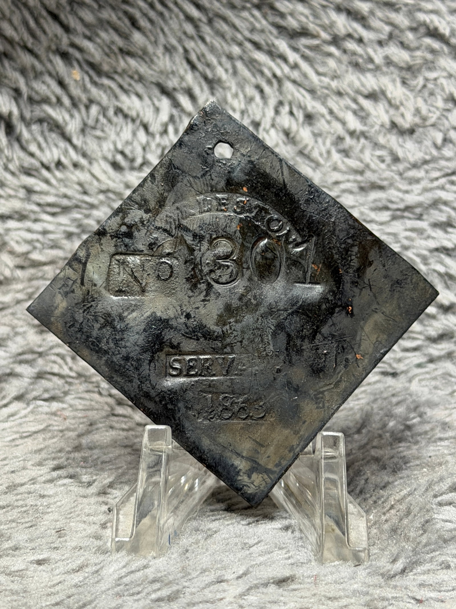 1860 Charleston No. 301 Servant Slave Hire Identification Tag: Dated 1860 Charleston slave hire identification tag featuring a diamond-shaped metal form with a pierced suspension hole at the upper point. The face is stamped with an arched “CHARLESTON” des