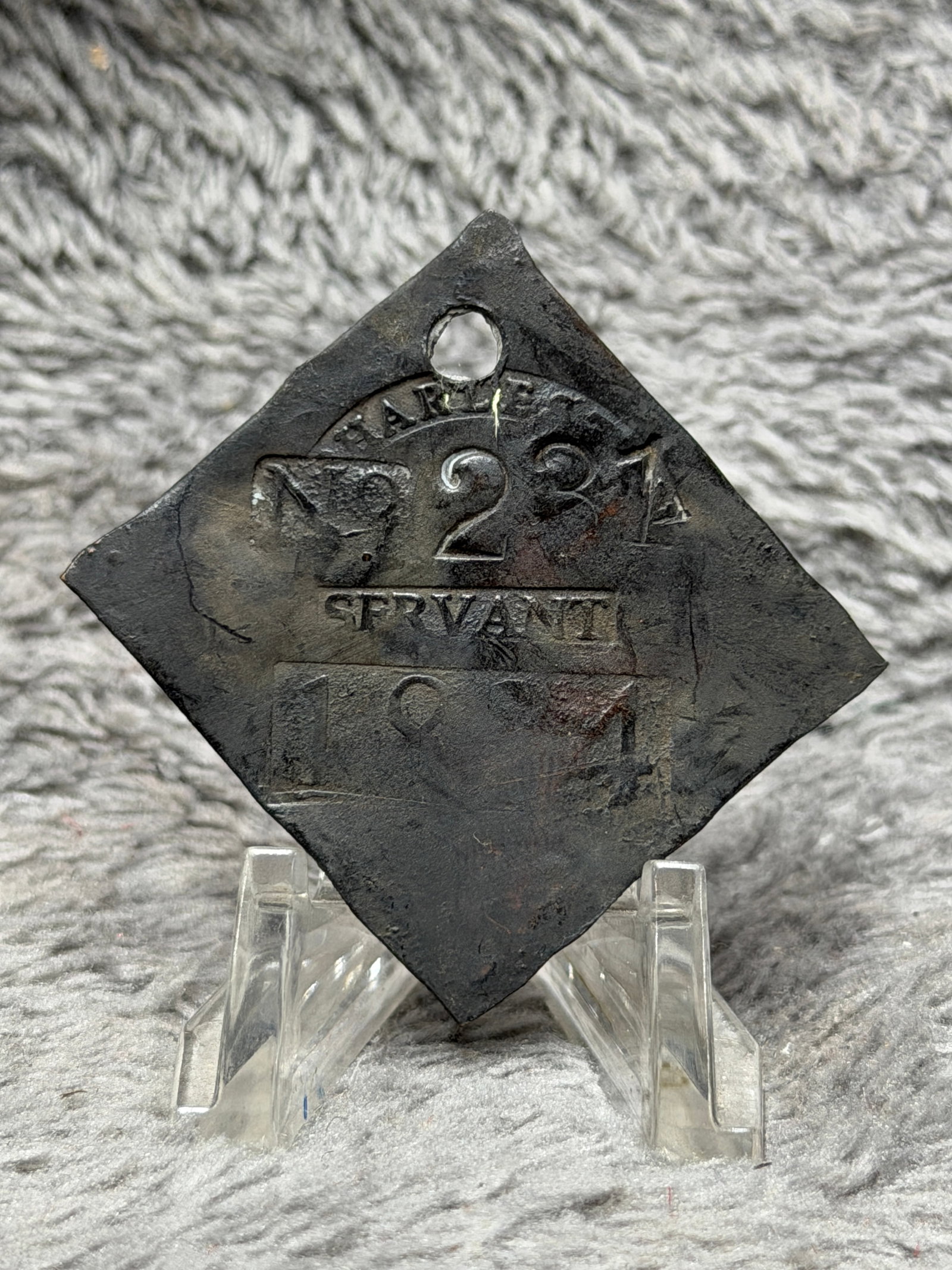 1824 Charleston No. 224 Servant Slave Hire Identification Tag: Dated 1824 Charleston slave hire identification tag featuring a diamond-shaped metal form with a pierced suspension hole at the upper point. The face is prominently stamped with an arched “CHARLESTO