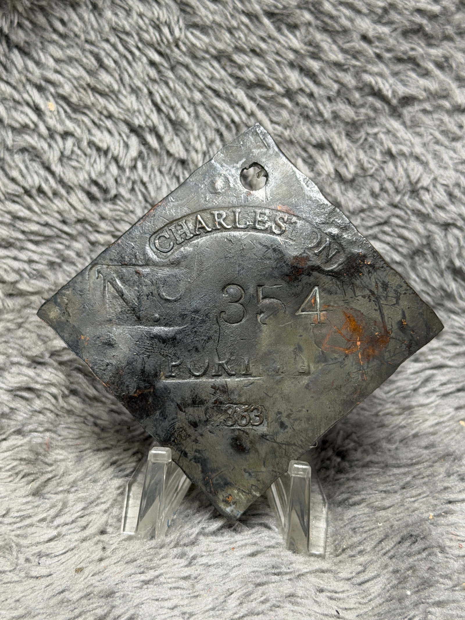 1863 Charleston No. 354 Porter Slave Hire Identification Tag: Civil War-era 1863 Charleston slave hire identification tag featuring a large diamond-shaped metal form with a pierced suspension hole at the upper point. The face is prominently stamped “CHARLESTON