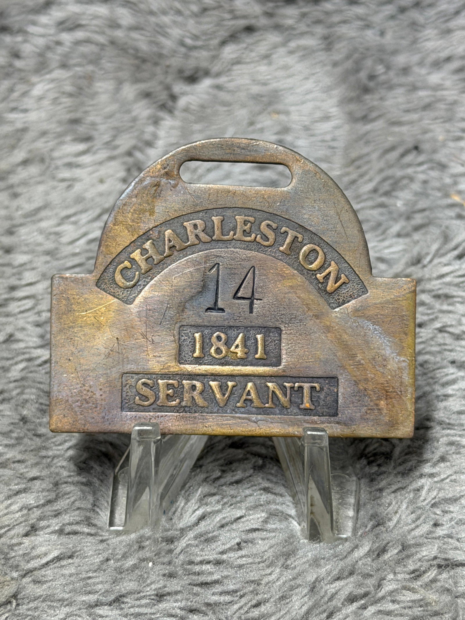 1841 Charleston No. 14 Servant Slave Hire Identification Tag: Pre-Civil War 1841 Charleston slave hire identification tag featuring a distinctive brass-toned rectangular form with a rounded upper section and elongated suspension slot for attachment or wear. The 