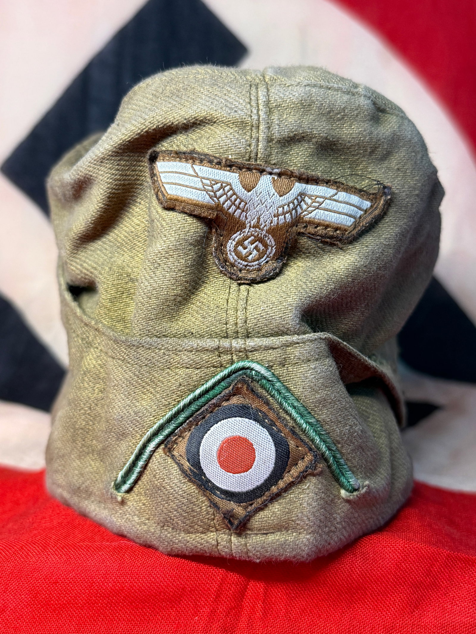 WWII German Afrika Korps M40 Tropical Field Cap with Eagle, Cockade & Soutache: The cap is much better identified as a German M40 tropical field cap associated with the Afrika Korps / tropical uniform, rather than a standard continental Gebirgsjäger field cap. The olive-tan trop