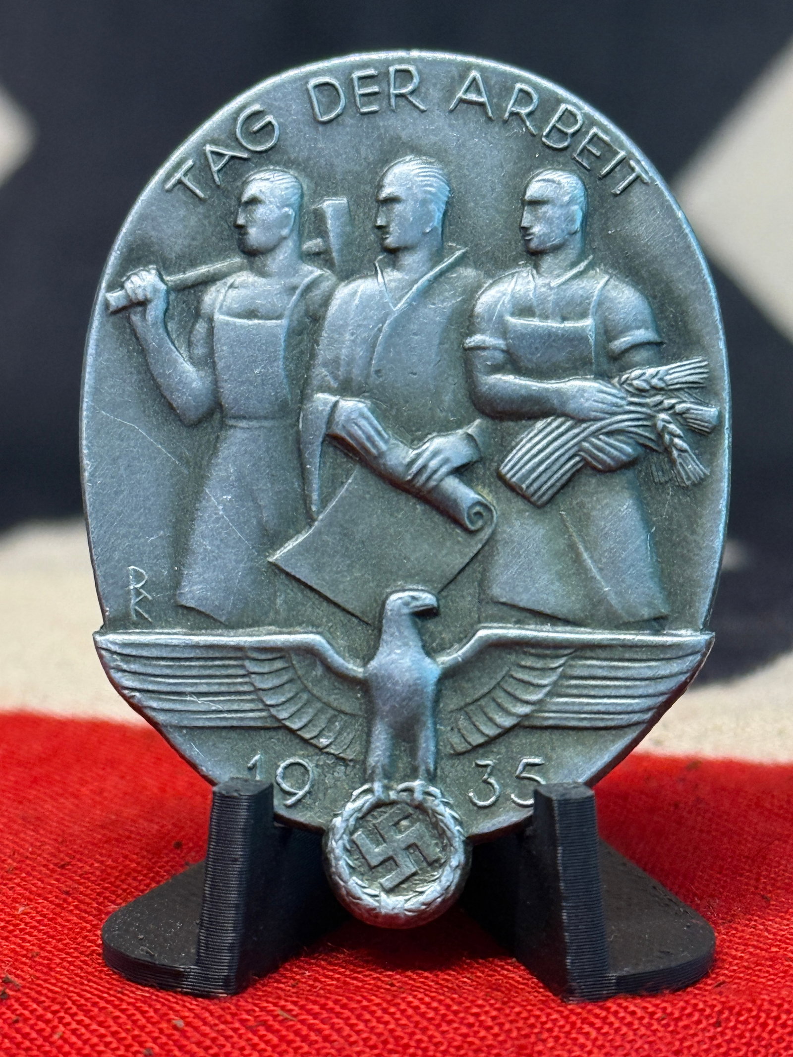 1935 German “Tag der Arbeit?? National Labor Day Badge – Chr. Bauer, Welzheim: A substantial silver-colored commemorative badge produced for the German “Tag der Arbeit” or “Day of Labor” observance of 1935. The face presents three idealized workers representing i