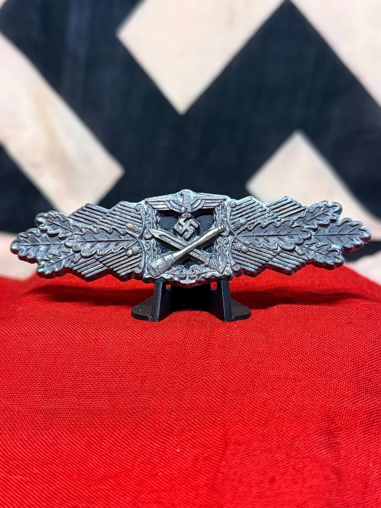 WWII German Close Combat Clasp in Silver – Nahkampfspange: A substantial WWII German Close Combat Clasp (Nahkampfspange) displaying the distinctive elongated combat design instituted in 1942 for German soldiers who participated in close-quarters fighting. The