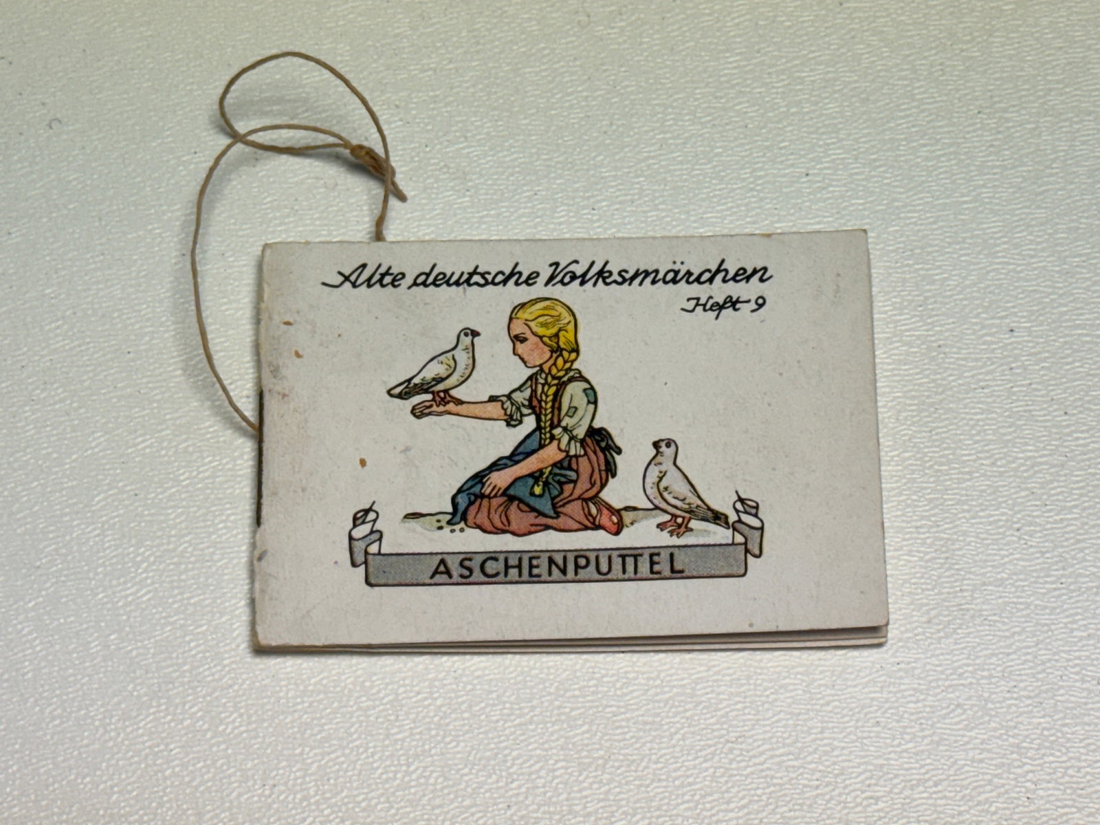 WWII German Winterhilfswerk WHW “Aschenputtel?? Cinderella Illustrated Folk Tale Booklet: WWII German Winterhilfswerk des Deutschen Volkes (WHW) miniature illustrated booklet from the “Alte Deutsche Volksmärchen” series, identified on the cover as “Heft 9” and titled “As