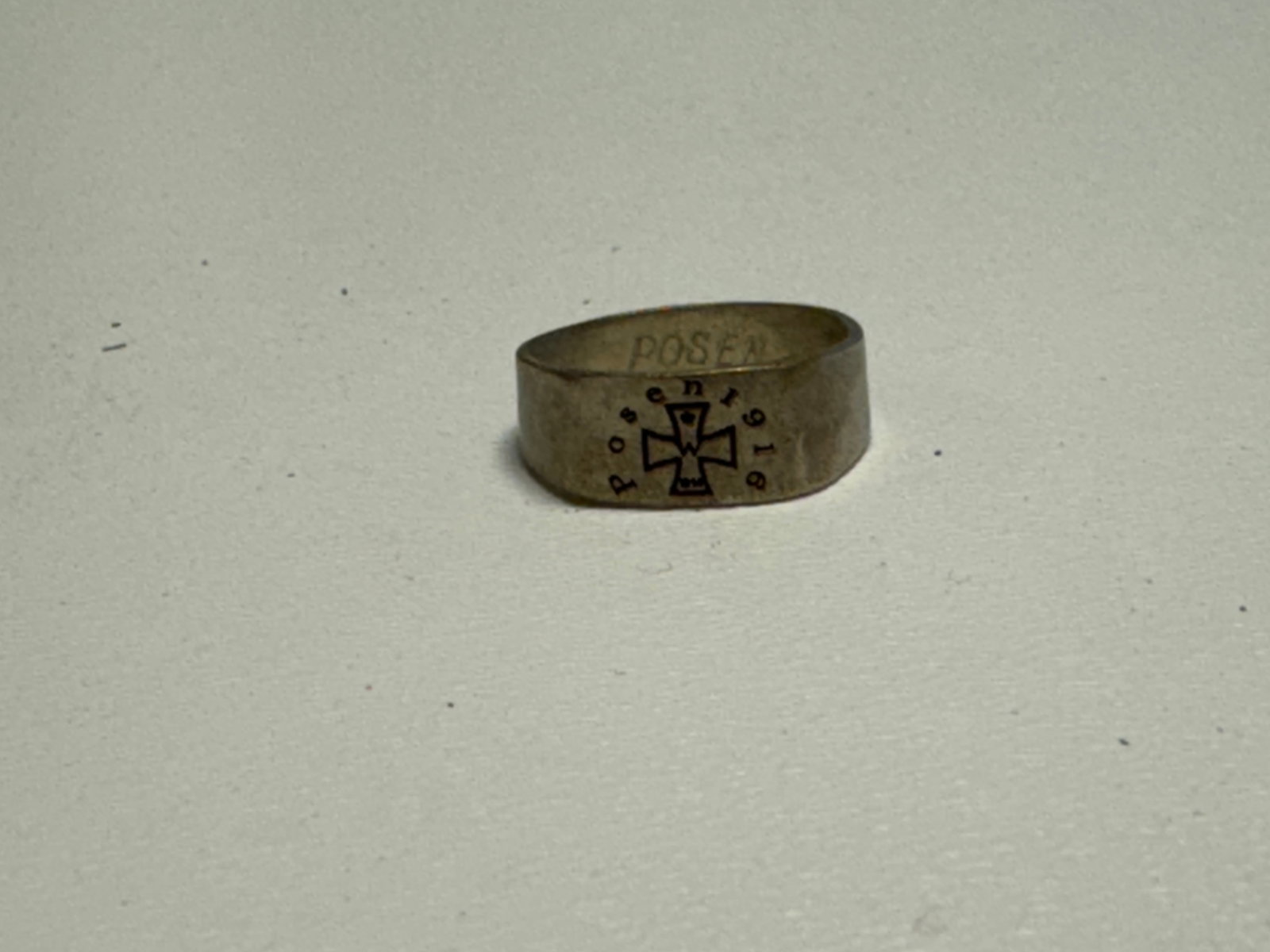 WWI German 1916 Posen Iron Cross Patriotic Trench Ring: WWI German patriotic finger ring featuring a broad band with a central Iron Cross motif surrounded by the inscription “Posen 1916,” referencing the wartime German city of Posen, today Pozna?, 