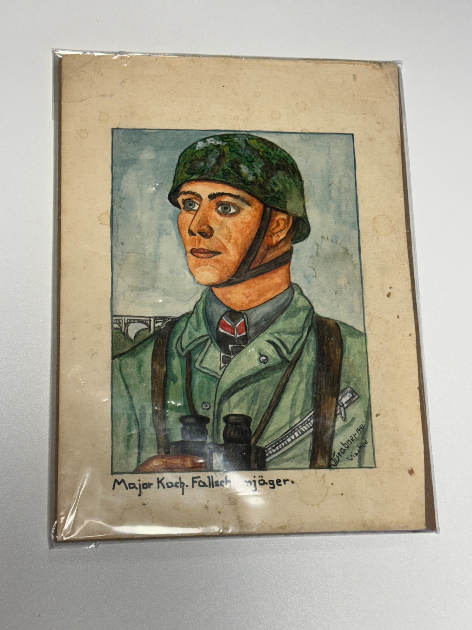 WWII German Fallschirmjäger Major Koch Paratrooper Hand-Painted Portrait: Striking WWII German military hand-painted portrait depicting a Fallschirmjäger paratrooper identified by the handwritten inscription beneath the image as “Major Koch. Fallschirmjäger.” The 