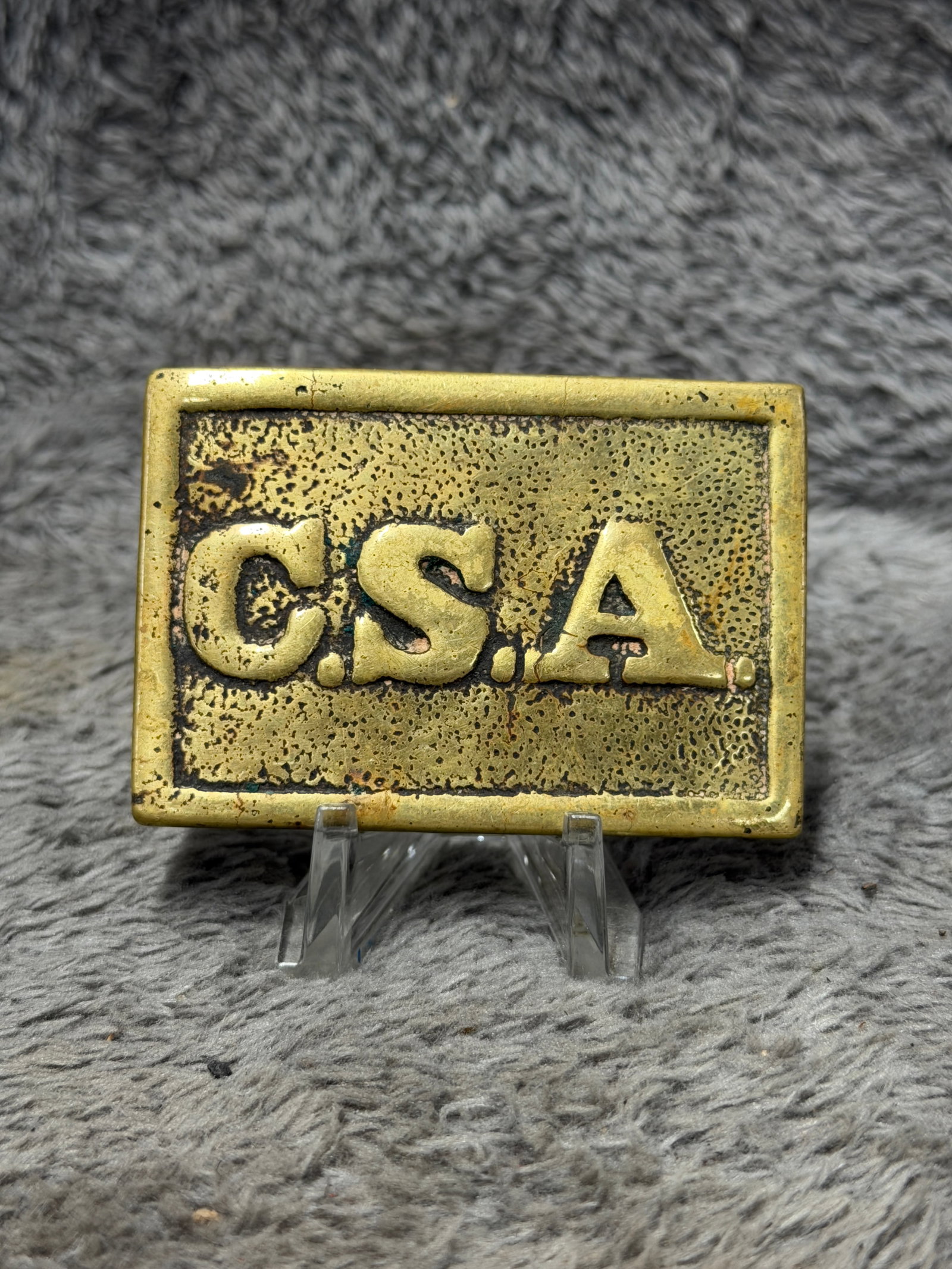 Civil War Confederate CSA Enlisted Soldier Brass Belt Plate Buckle: Striking Civil War Confederate States of America belt plate featuring a rectangular brass face with a raised outer border and large, prominently cast “C.S.A.” lettering across the center. The 