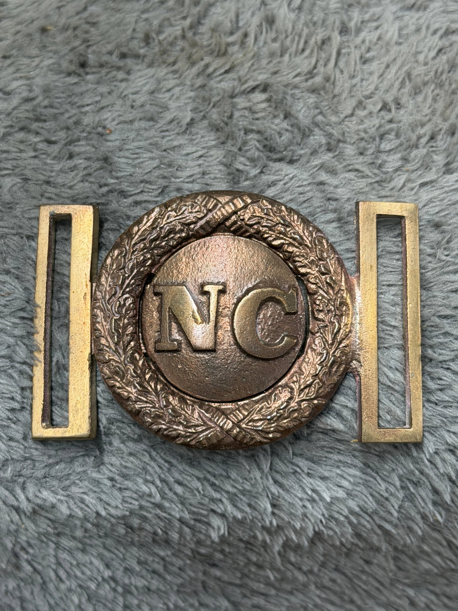 Civil War Confederate CSA North Carolina “NC?? Wreath Two-Piece Belt Plate Buckle: Striking Civil War-era Confederate North Carolina belt plate featuring a prominent raised “NC” device on a circular center section surrounded by an ornate wreath of intertwined foliage and cro
