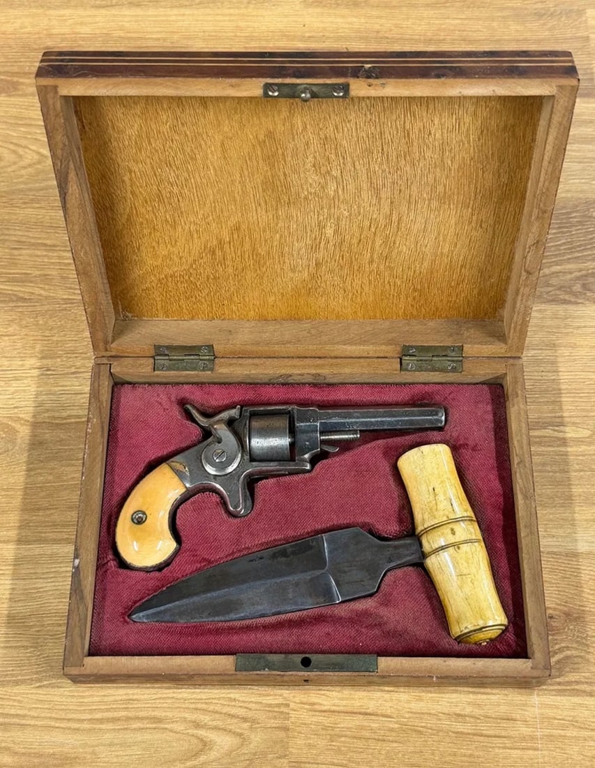 1800s Cased Pocket Revolver & Push Dagger Gentleman’s Traveling Self-Defense Set: Striking 19th-century gentleman’s cased personal defense set consisting of a compact spur-trigger pocket revolver accompanied by a substantial push dagger, both housed together in a fitted decorativ
