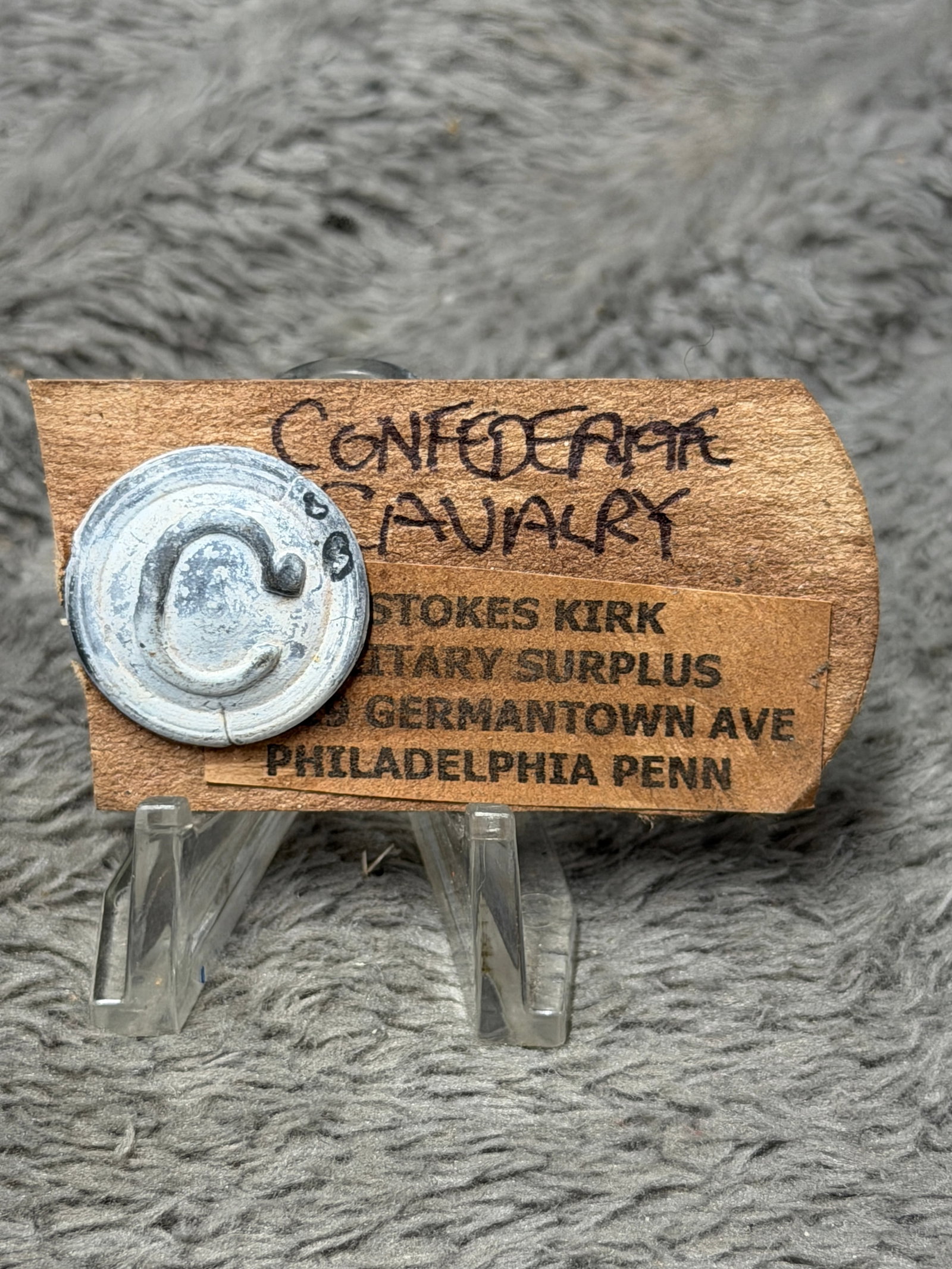Civil War Confederate Cavalry “C?? Company Hat Insignia – W. Stokes Kirk Collection: Circular stamped metal military insignia dominated by a large raised letter “C,” traditionally associated with a company designation when used as Civil War-era military hat brass. The piece is
